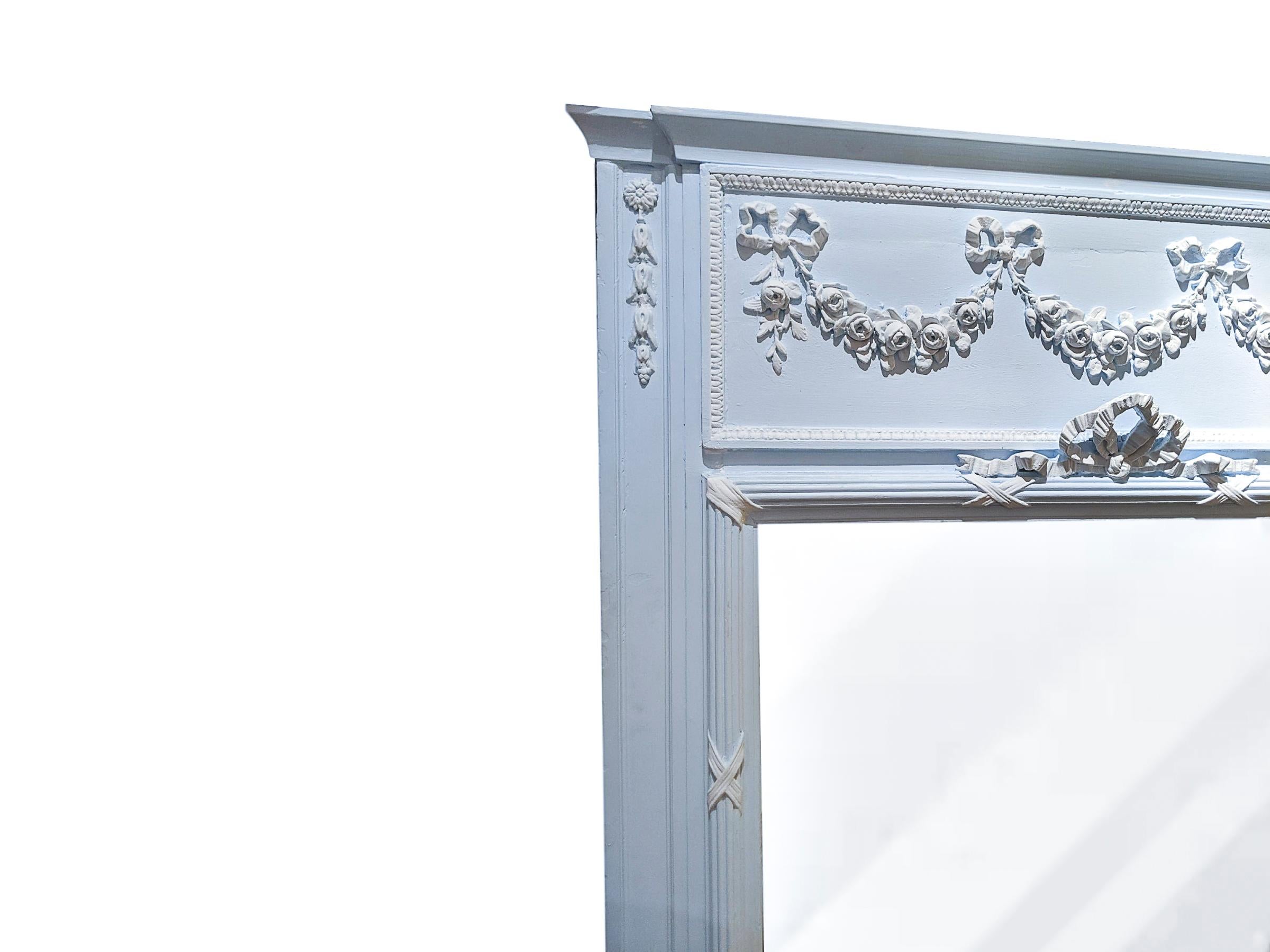 Early 19th century French Trumeau mirror in powder blue and white molded gesso floral swags. Readed and ribbon posts.