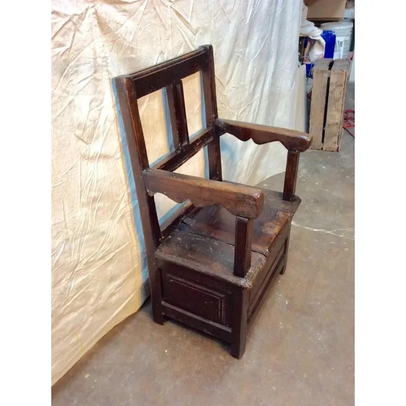 Found in the South of France this early 19th century arm chair features a hinged seat for storage. Handmade and brutalist in style this chair will be the perfect addition any room, a large kitchen, hallway, children's bedroom or by the fire