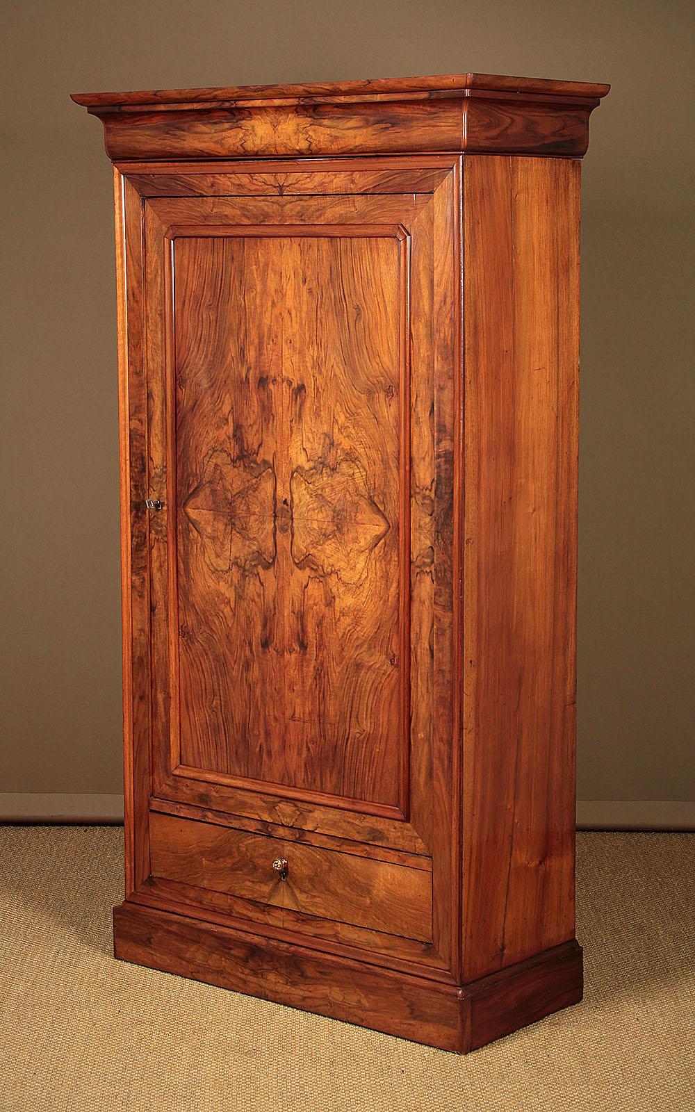 An attractive early 19th century burr walnut linen press, wardrobe or hall cupboard with useful narrow dimensions. Could be used as a kitchen store cupboard or perhaps a shoe or hall locker. Single door cupboard fitted inside with four adjustable