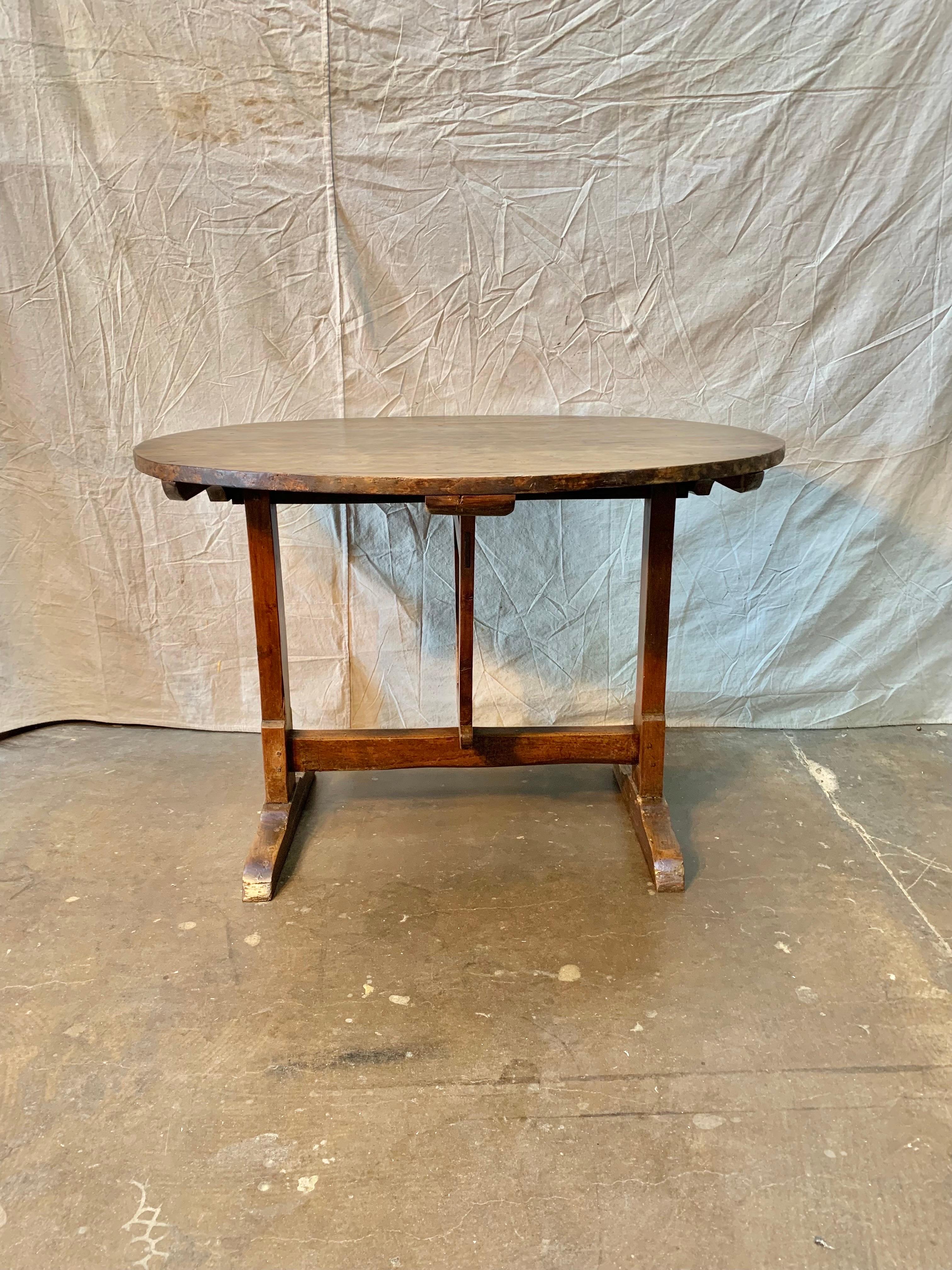 Early 19th Century French Walnut Wine Tasting Table, also known as a vendage or vigeron table, which was once used in the vineyards of France for tasting wine or enjoying a meal. This table would be suitable for use as a center table, small dining