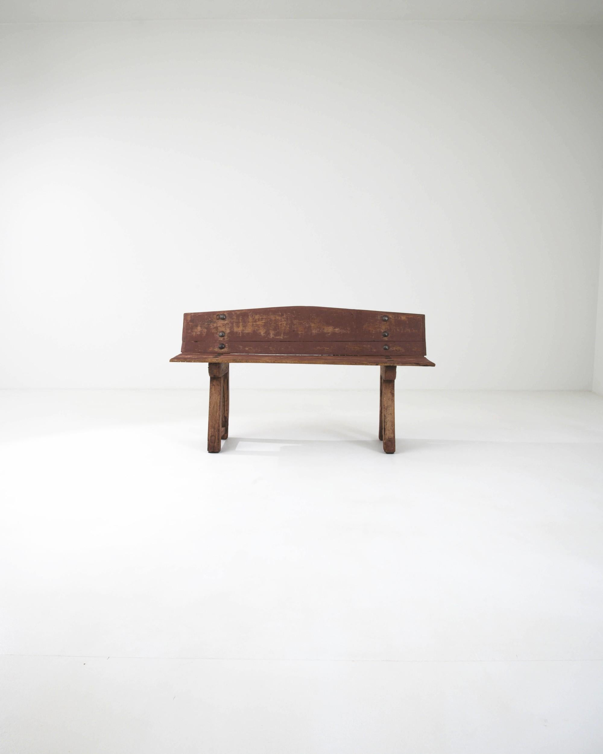 The appealing form of this rustic wooden bench gives it a timeless charm. Made in France in the early 1800s, the simple yet inviting design evokes the sunlit squares of small Provincial villages, where the townsfolk would sit to read the newspaper
