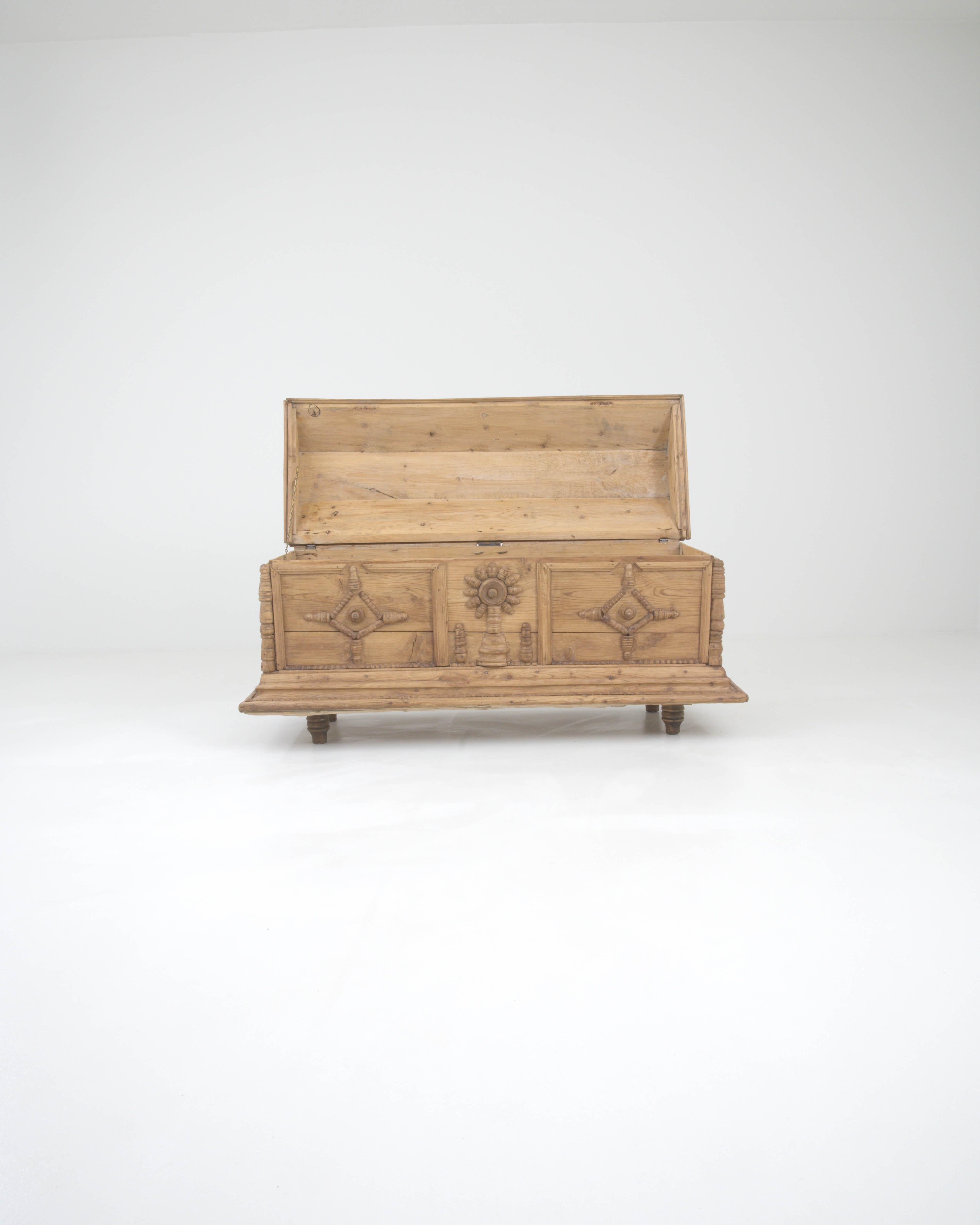 Step back into the elegance of the early 19th century with this exquisite French wooden chest, a masterpiece that resonates with the period's artistry and finesse. Handcrafted with an eye for detail, this timeless piece showcases ornamental carvings