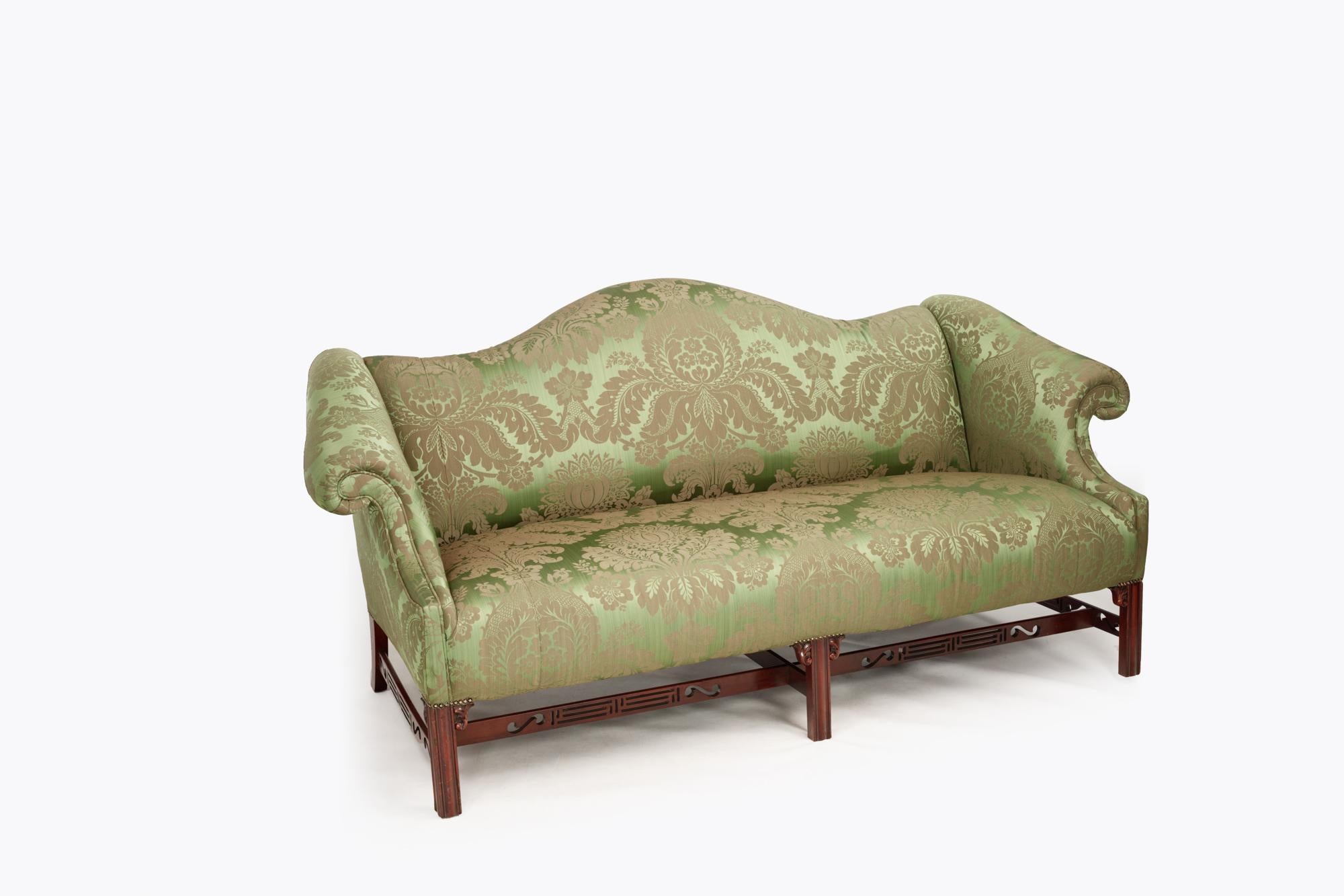 Early 19th Century George III Gainsborough camelback sofa with scrolled arms, raised over six moulded marlborough legs supported by distinctive pierced stretchers which incorporate shaped corner brackets. This piece has been newly upholstered in