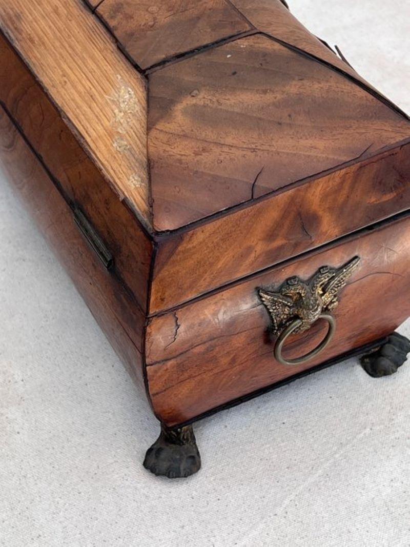 Exquisite George III inlaid tea caddy from the early 19th century. 
Remarkable design with a distinct starburst escutcheon, evoking timeless charm.
Measurements: 13