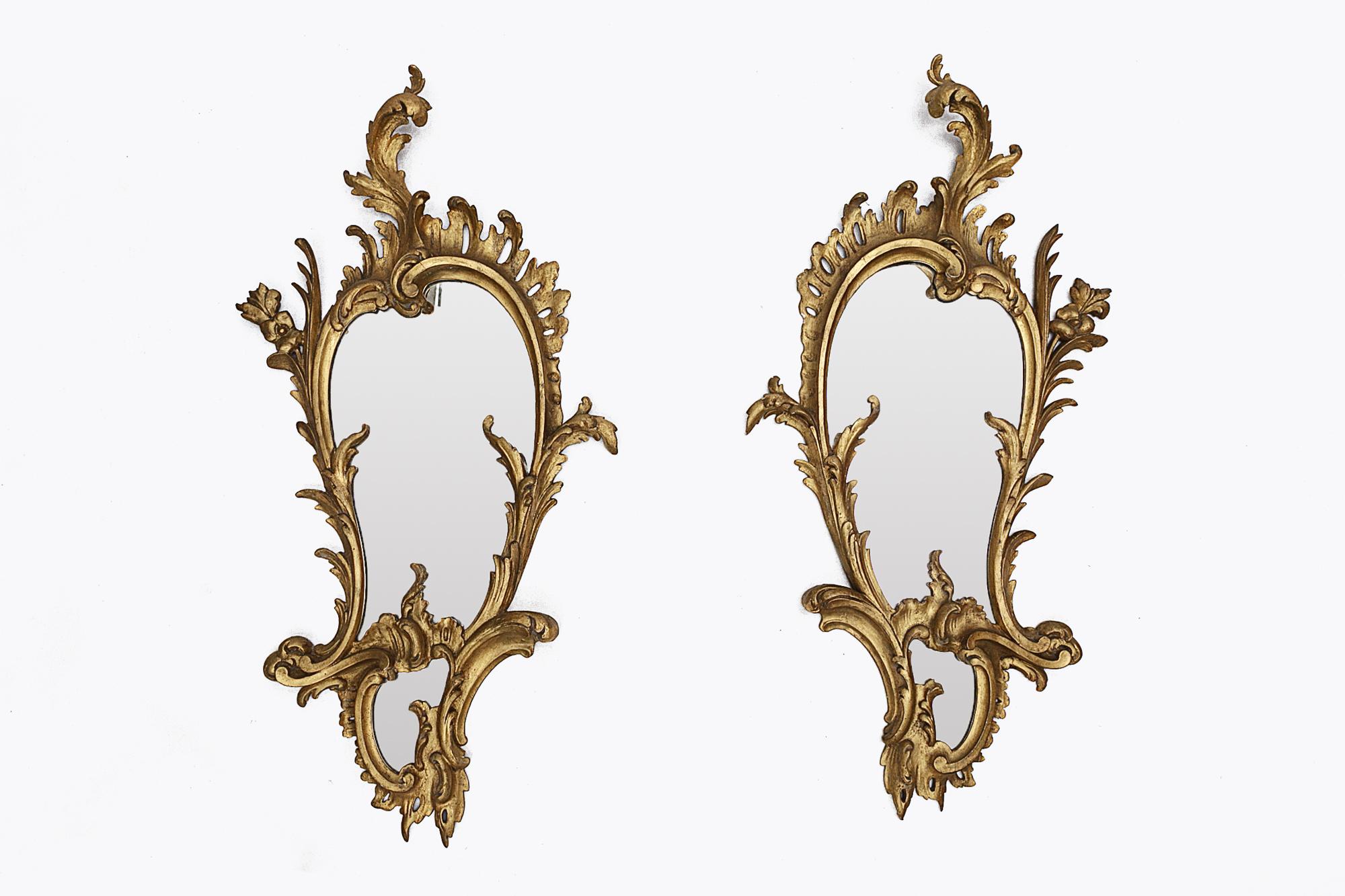 19th century Irish pair of giltwood mirrors of asymmetrical form, with scrolled acanthus leaf, floral and pierced rocaille frame, surmounted by an acanthus spray cresting, stamped to the reverse:

‘S.Bregazzi, Carver, Gilder and Picture Framer, 10