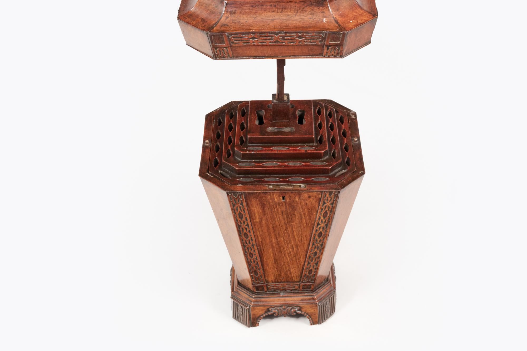 Early 19th Century George III pair of mahogany knife urns. Of square form with carved blind fretwork design. The domed and finialled tops lift to reveal fitted interiors.