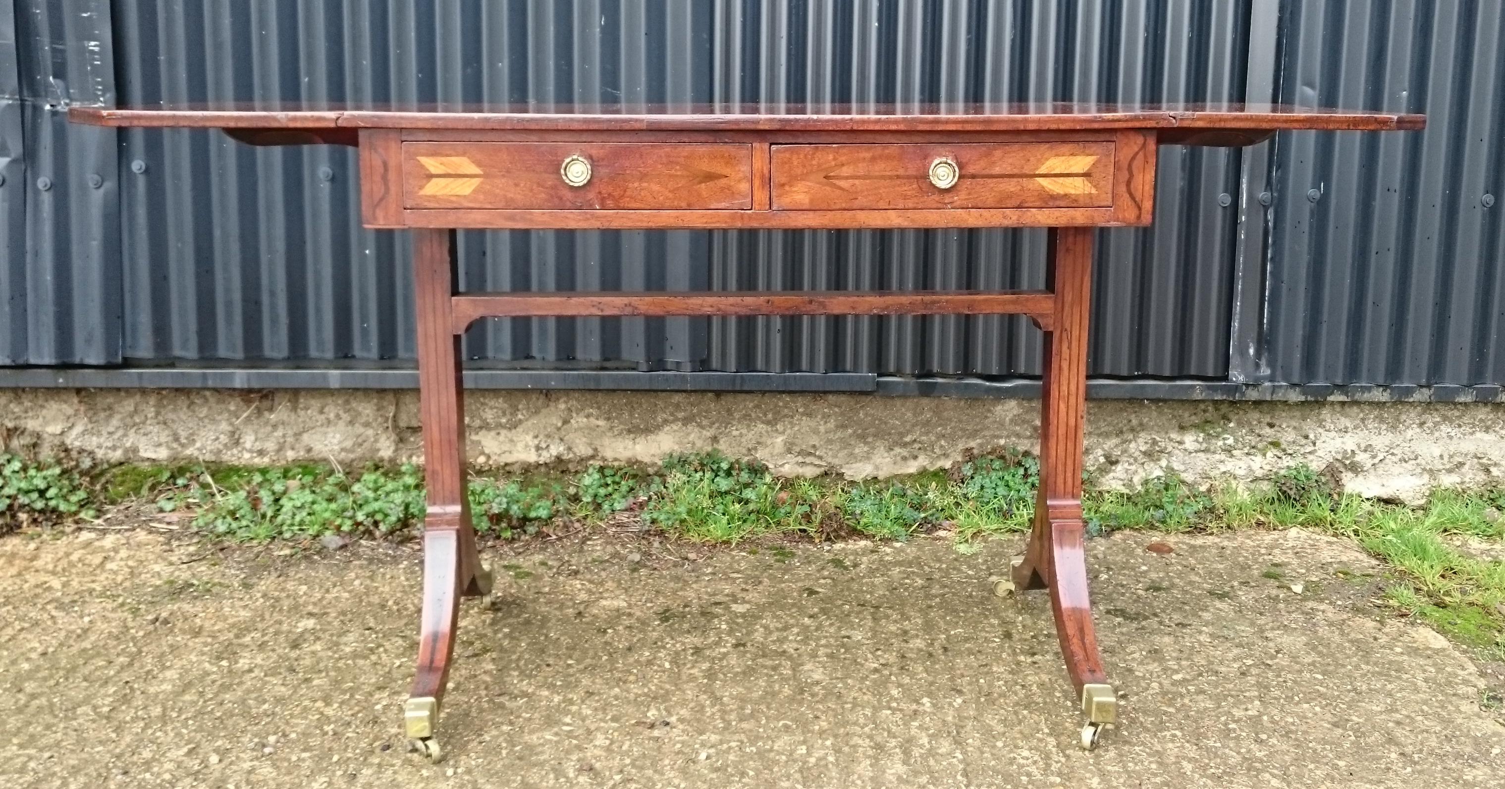 Early 19th century George III period mahogany antique sofa table. This sofa table is a real delight, it has all the sought after details such as the four splay end support, high stretcher and it is free standing. As well as this the timber has a