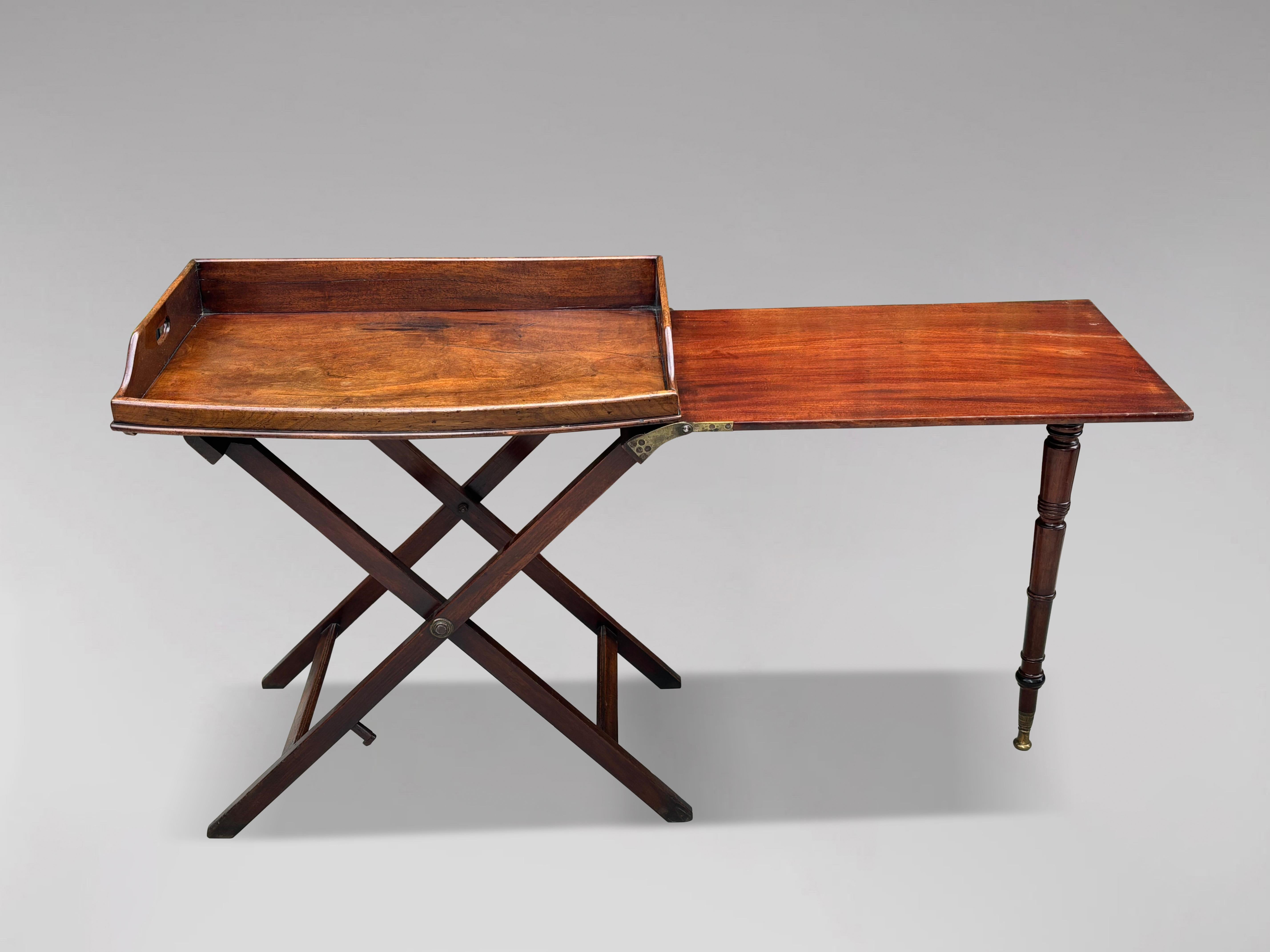 A stunning and rare late 18th to early 19th-century George III period mahogany military campaign butler's tray table on stand, which extends to double its size, in excellent original condition. It features a rectangular bow-fronted tray with shaped