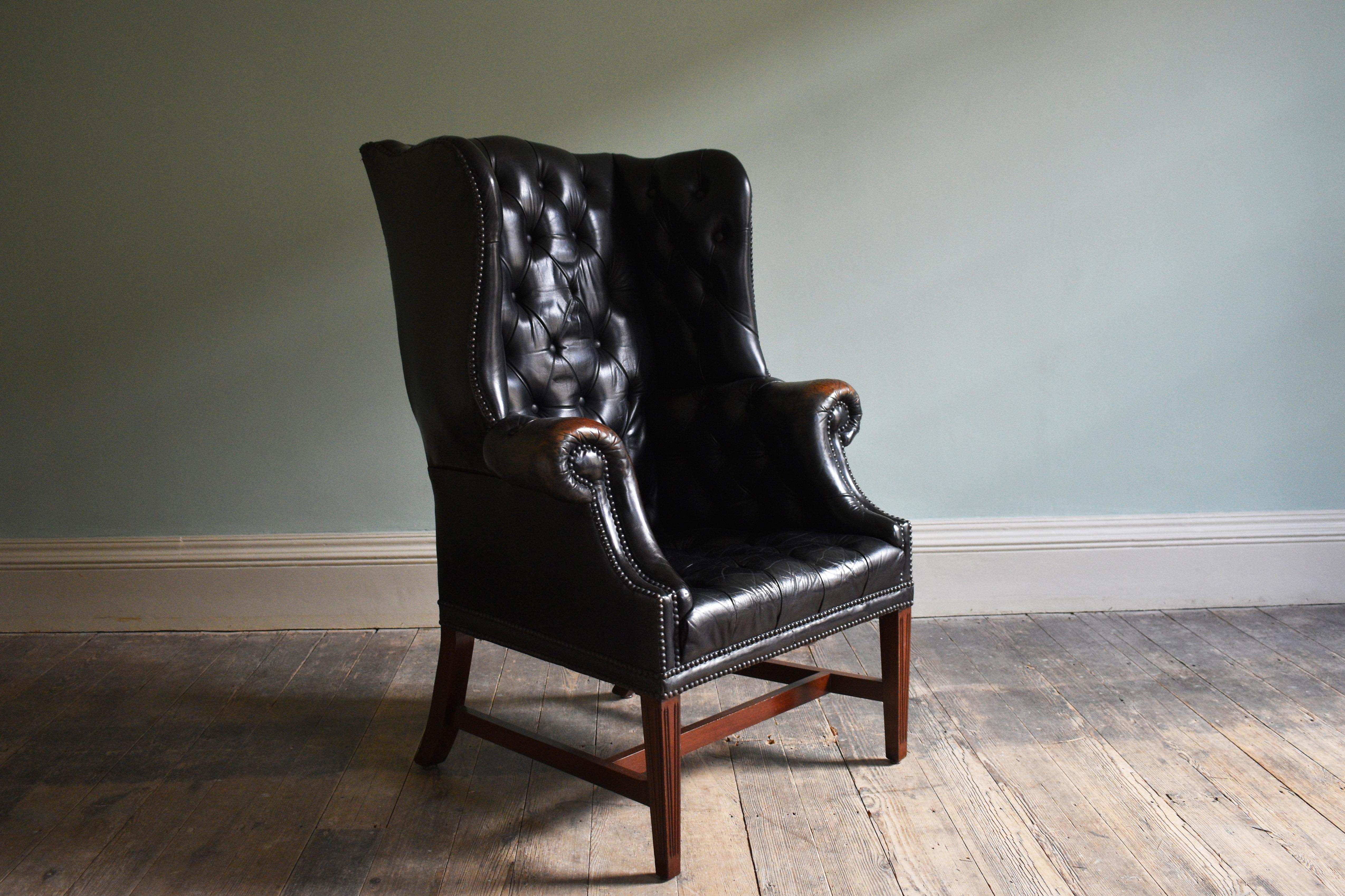 English Early 19th Century Georgian Black Leather Upholstered Wingback Armchair For Sale