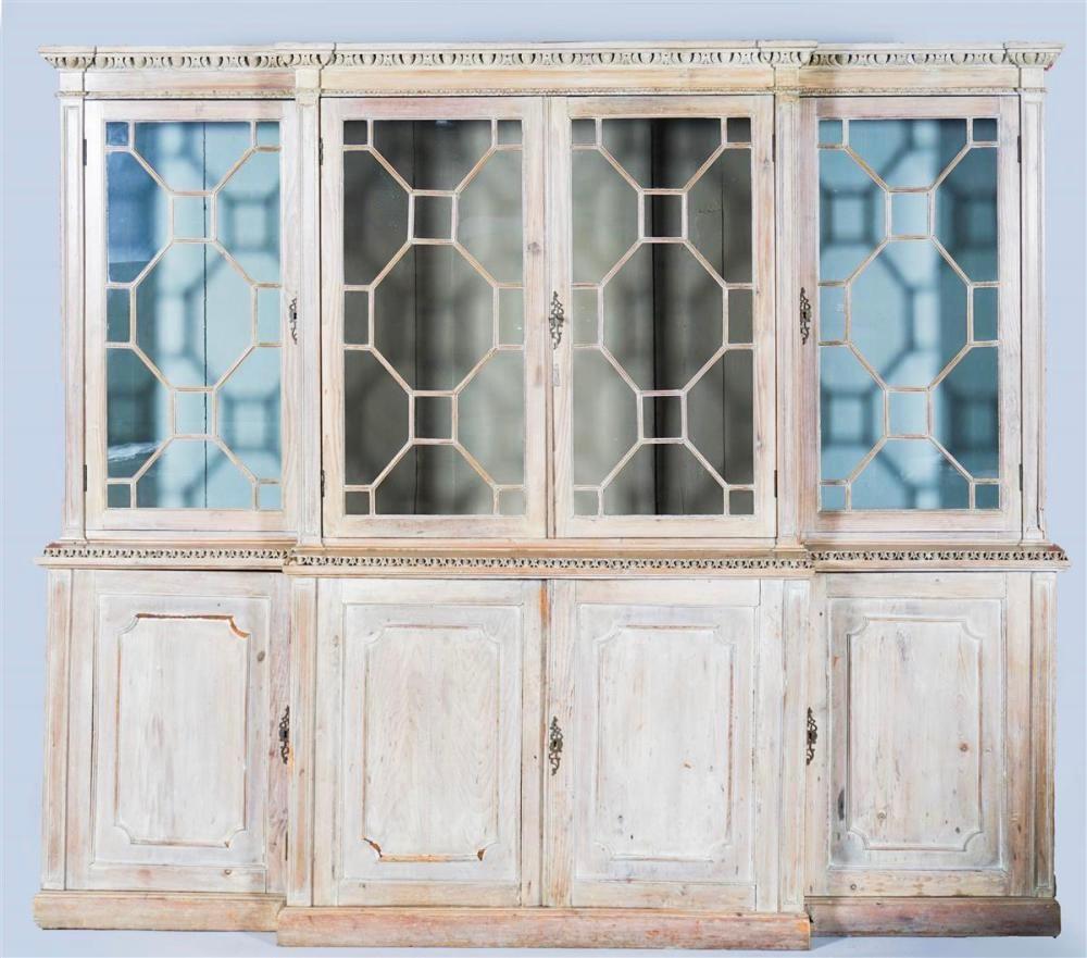 Wonderfully presented Georgian bleached pine breakfront bookcase. George II carved egg and dart in upper and middle moldings. Raw pine and finish may be original with cleaning over the decades. No indication of an exterior paint having been removed.