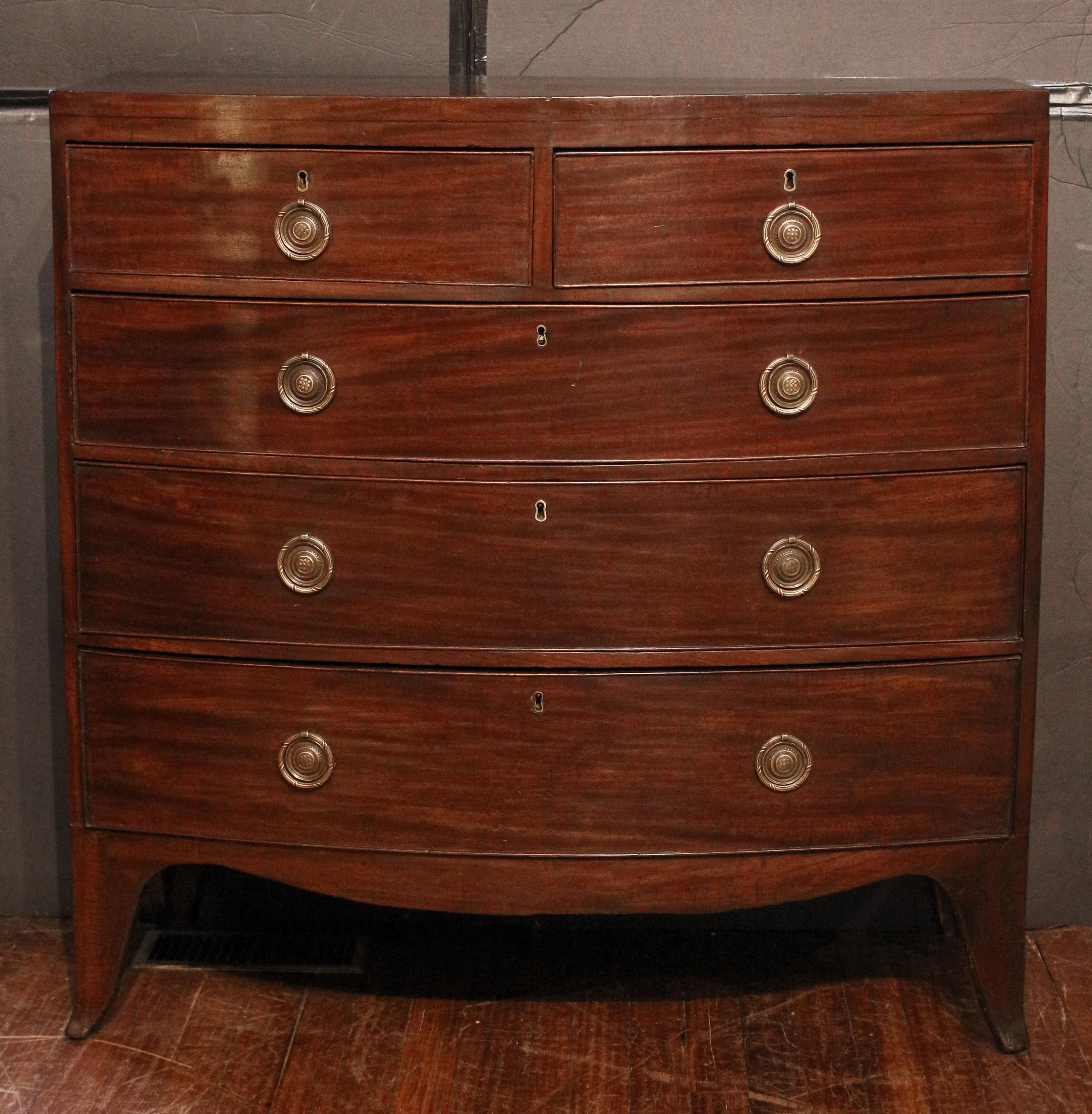 Early 19th century bowfront chest of drawers, English. Georgian period. Bowfront, 2 short over 3 long graduated drawers. Raised on French splay feet. Shaped aprons. Caddy top with ebony stringing along the front. Replaced period style high quality
