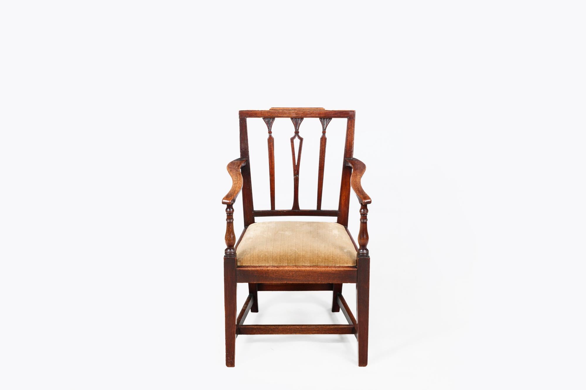 Early 19th Century Georgian children’s mahogany chair with simple square backrest featuring three delicately fluted column splats terminating in carved foliate capitols, and pierced detail to central splat. With S-curved armrests, turned supports