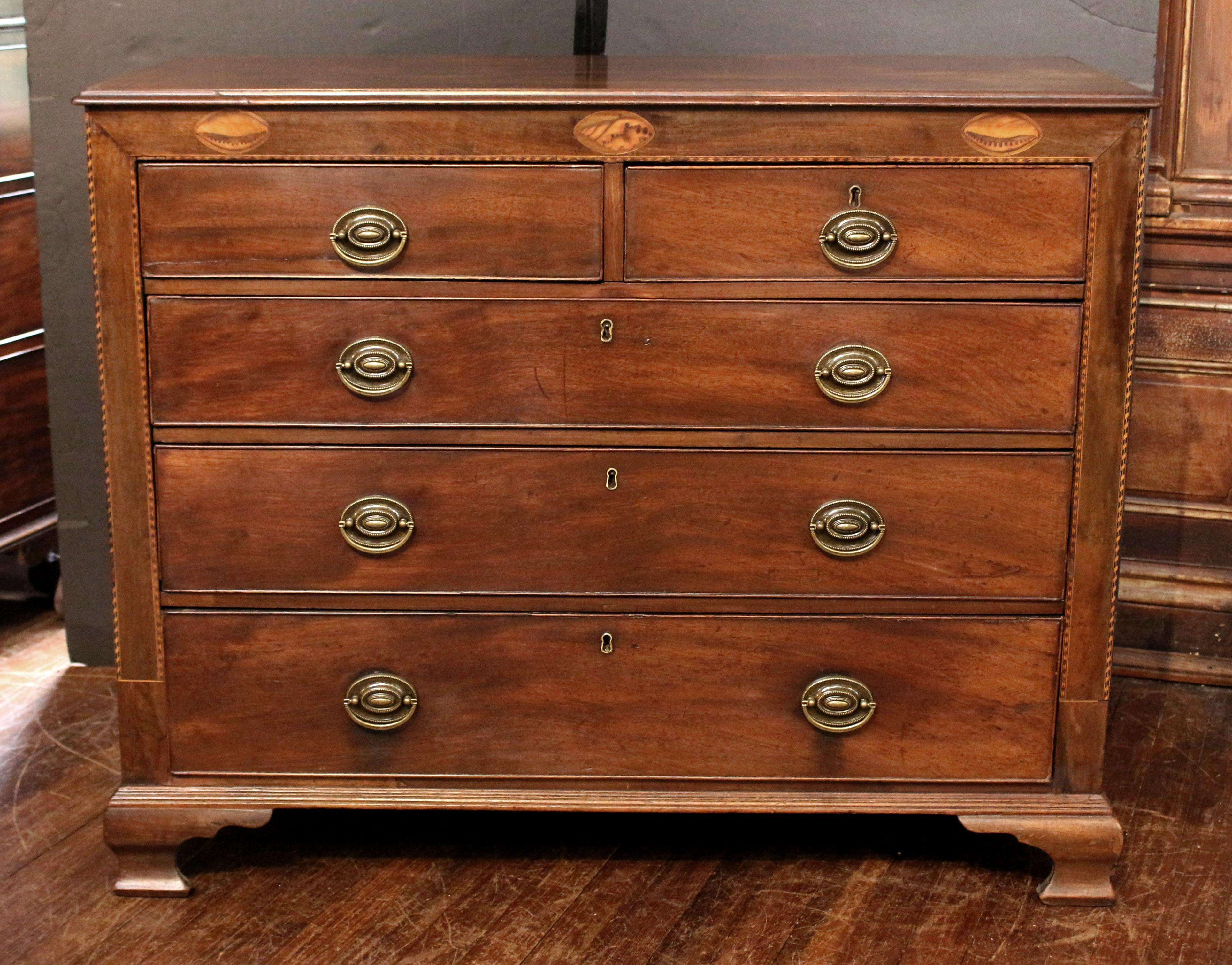 Early 19th century Georgian chest of drawers, English. Form typical of the north of England. Ogee bracket feet. Extensive barber pole inlays (minor losses). Three oval shell inlays across the frieze. Molded top. Oak secondary wood. Replaced oval
