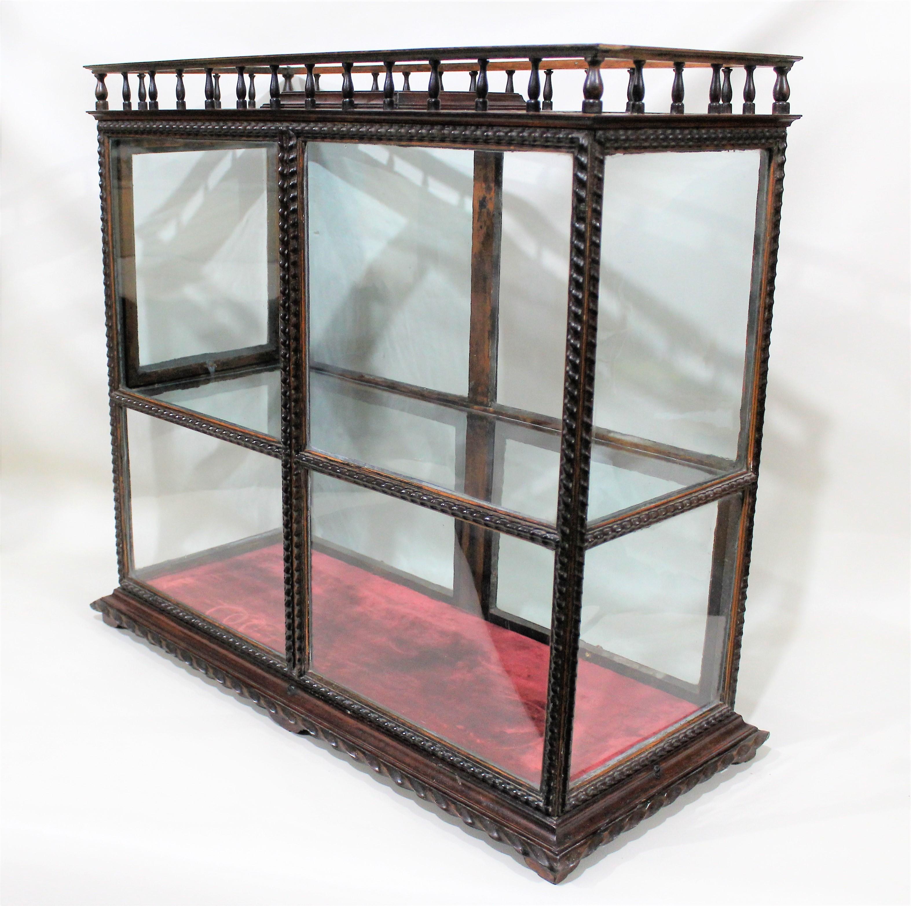 Georgian tabletop display cabinet with period glass and carved wood frame and gallery.