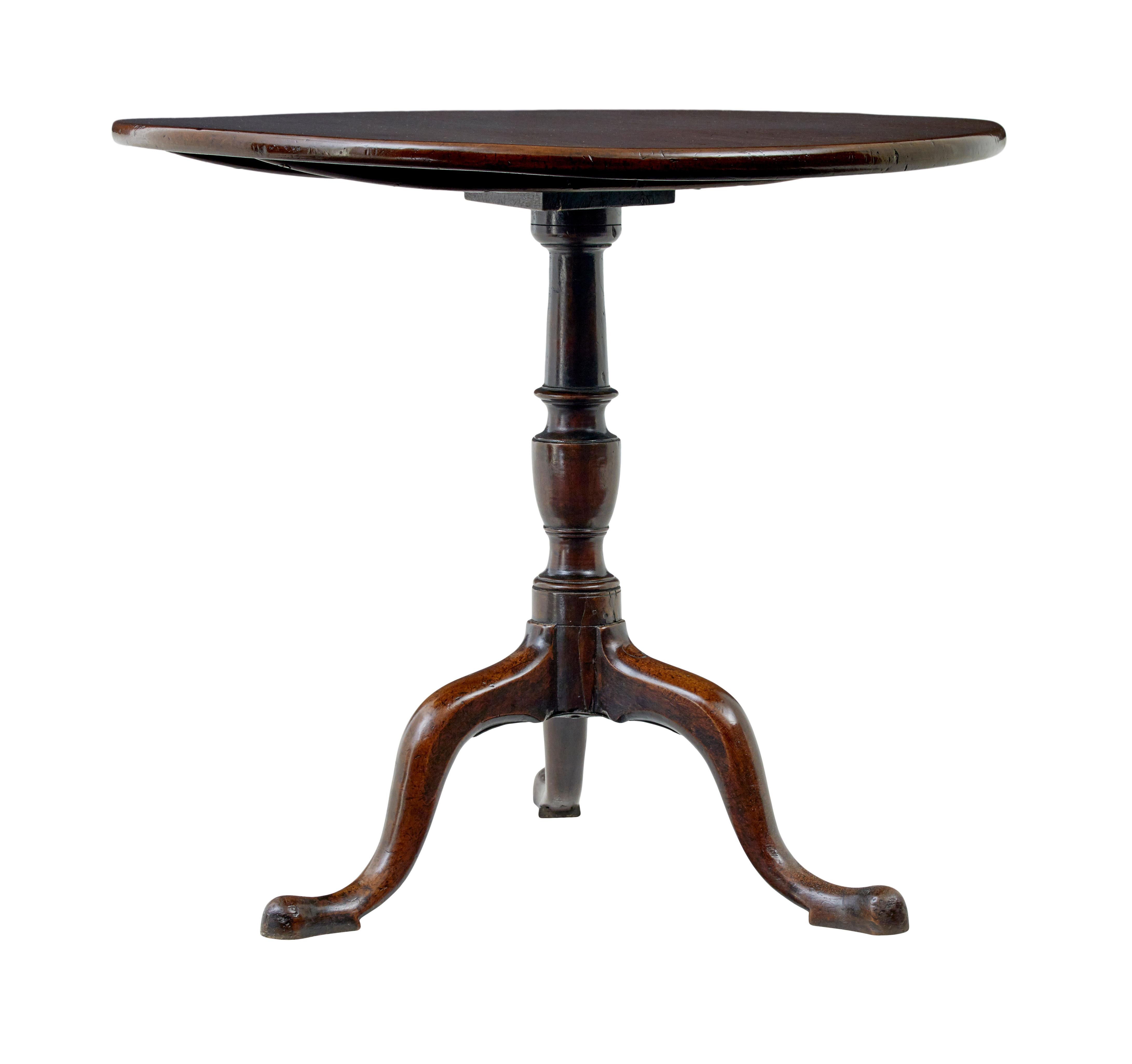 Early 19th century Georgian tripod table circa 1800.

Good quality Georgian period tilt top mahogany wine table.

Circular top with bull nosed edge.  Functioning tilt mechanism.  Raised on a turned stem and 3 scrolling legs with hand carved pad