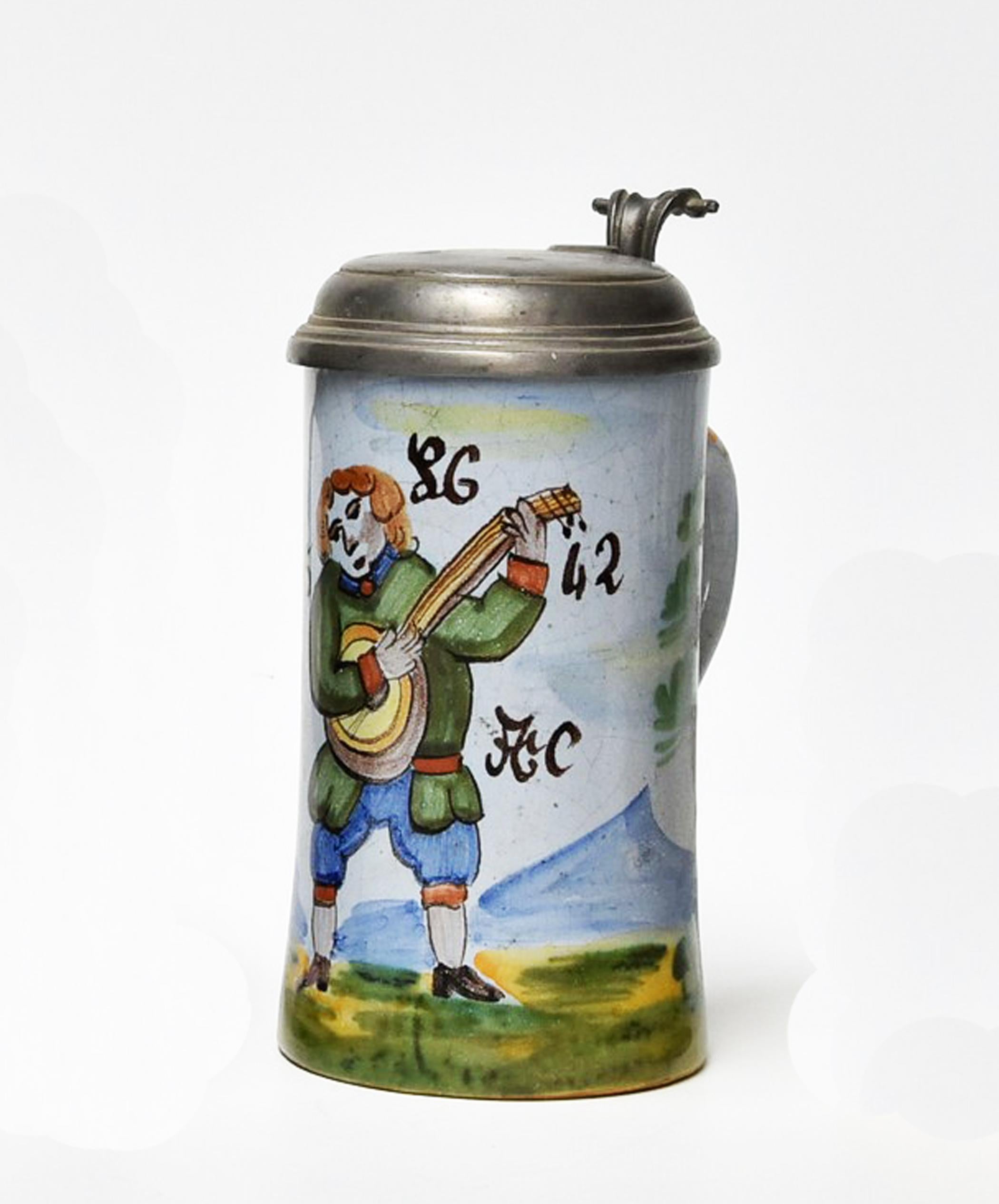Stoneware 1/2l beer stein with an original pewter hinged lid. The body is decorated with a player, original craquelure.
Made in Germany, circa 1820.