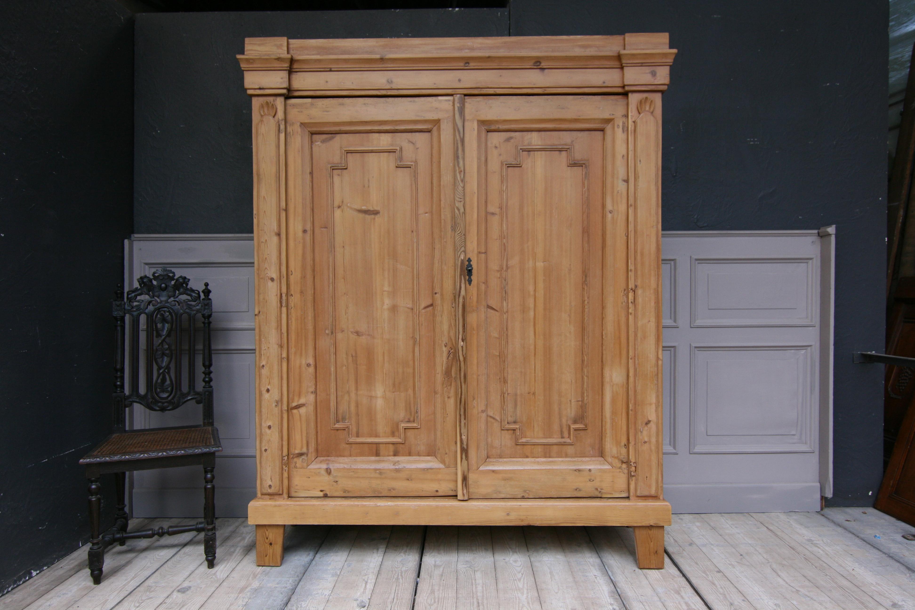 Provincial cabinet from Germany made of solid pine, circa from 1820.

 Four fixed shelves inside.

 Dimensions:
 195 cm high / 76.77 inch high, 
158 cm wide / 62.21 inch wide,
 53 or 57 (incl. header) cm deep / 20.87 or 22.44 (incl. header)
