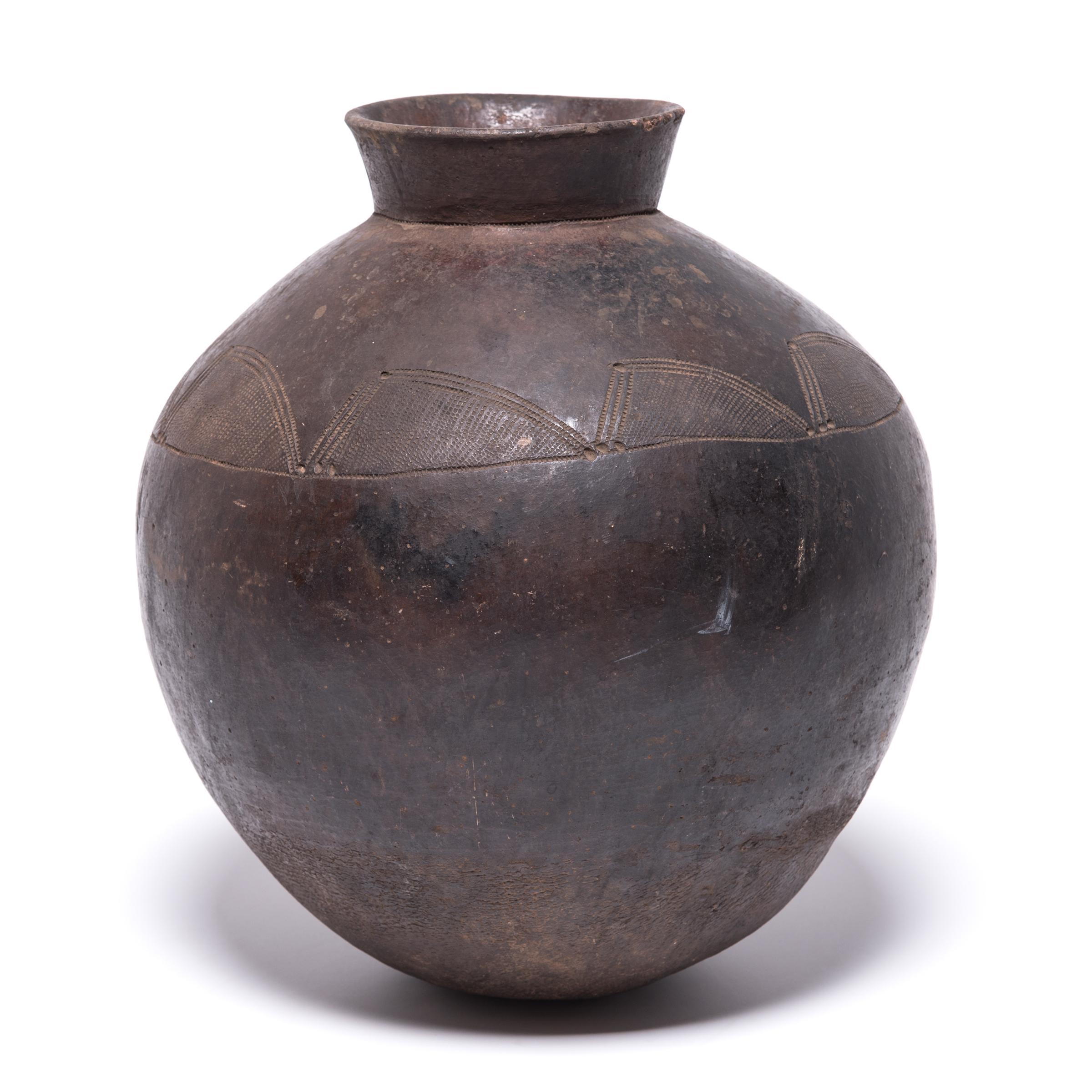 The Lobi peoples of Ghana and Burkina Faso have a deep focus on agriculture, leaving less of their time for artistic endeavors. This difference in focus makes a decorated vessel such as this a particularly rare find. The geometric engravings were