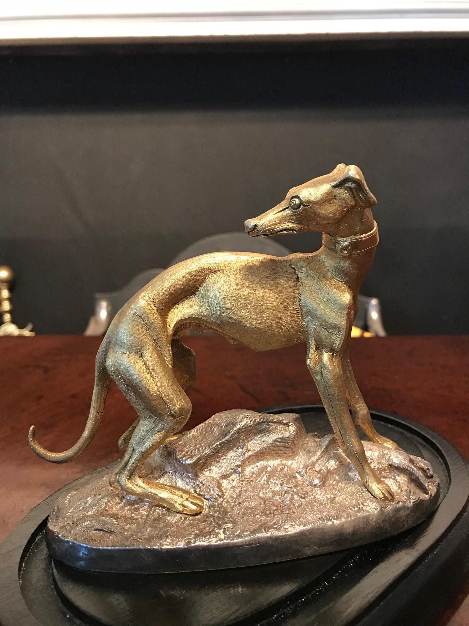 Early 19th century Regency gilt bronze statue in the form of a whippet presented within period glass cloche dome bell jar display case supported on fitted mahogany base.