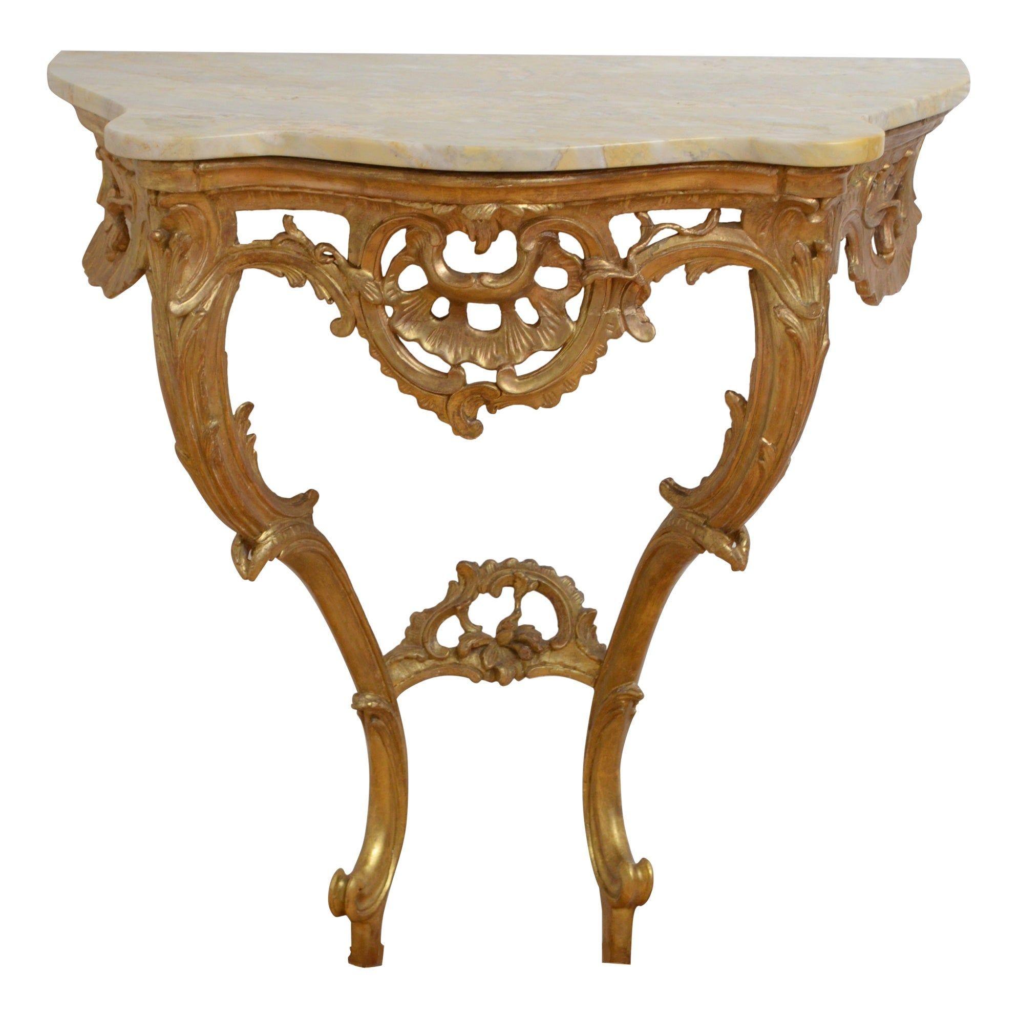 K0413 Attractive gilded console table of serpentine design, having original veined marble top above intricate frieze and 2 cabriole legs with foliage decoration, united by carved stretcher. This antique console is in home ready condition, circa