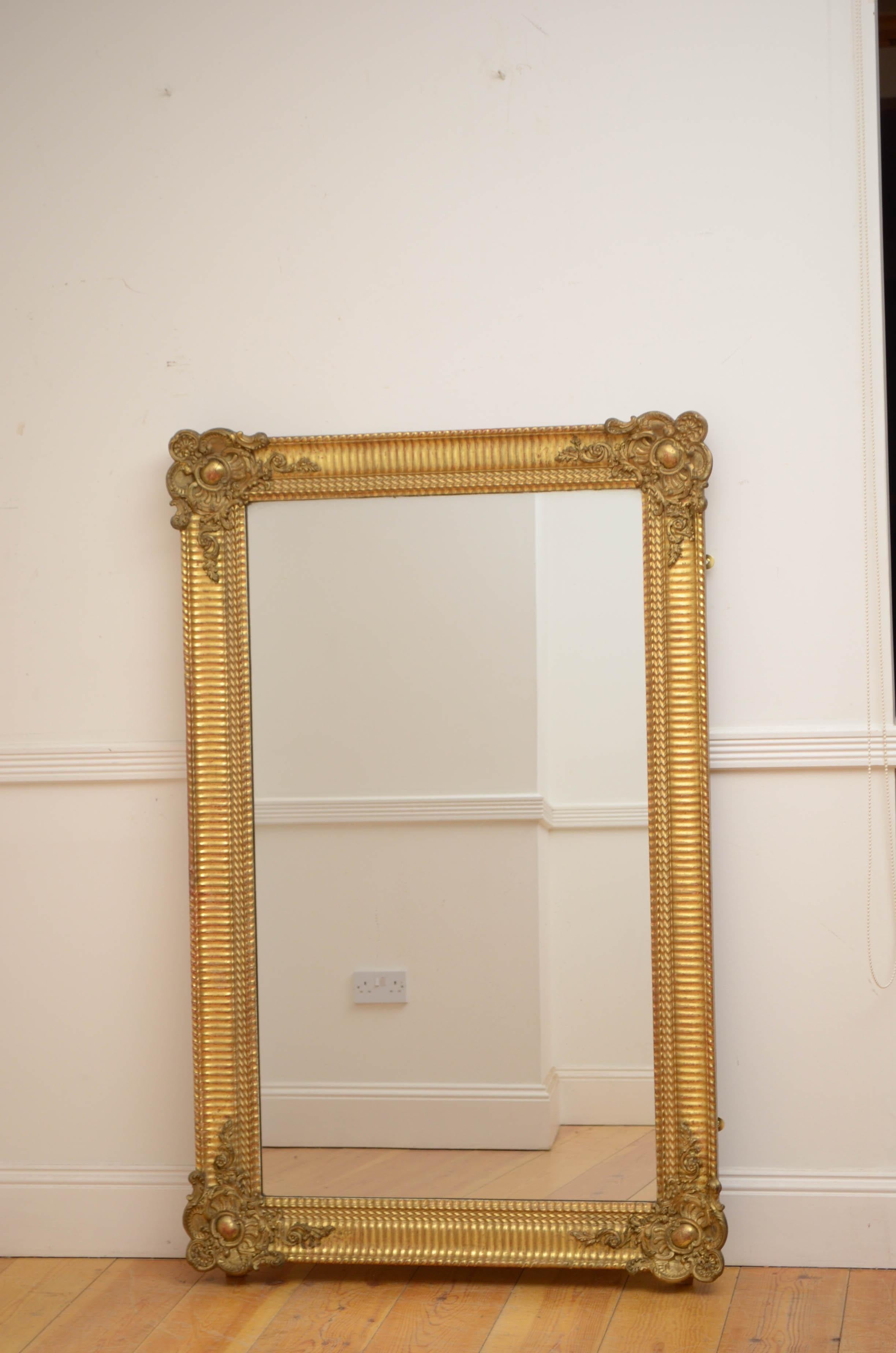 K0536 Super 19th century gilded wall mirror, having original mercury glass with some sparkle and air bubbles in beautifully carved gilt frame with scroll decorated corners. This antique mirror can be positioned both vertically and horizontally. The