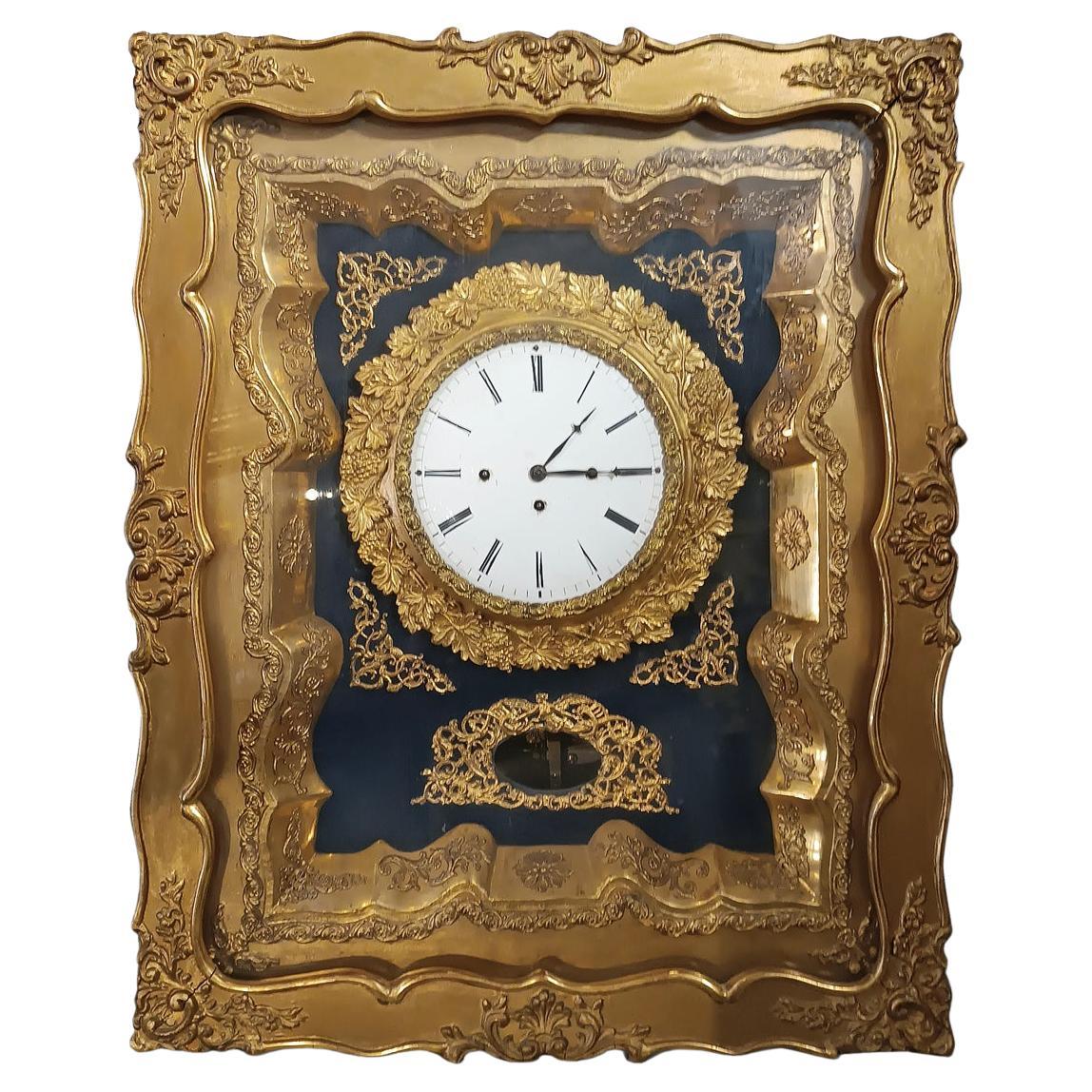 EARLY 19th CENTURY GOLDEN WALL CLOCK WITH MUSIC BOX