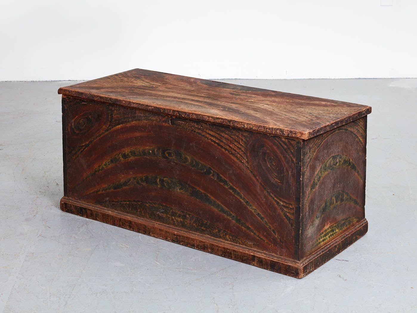 Good early 19th Century New England grain painted pine blanket chest with original whimsical painted surface, dovetail construction and pleasing form.