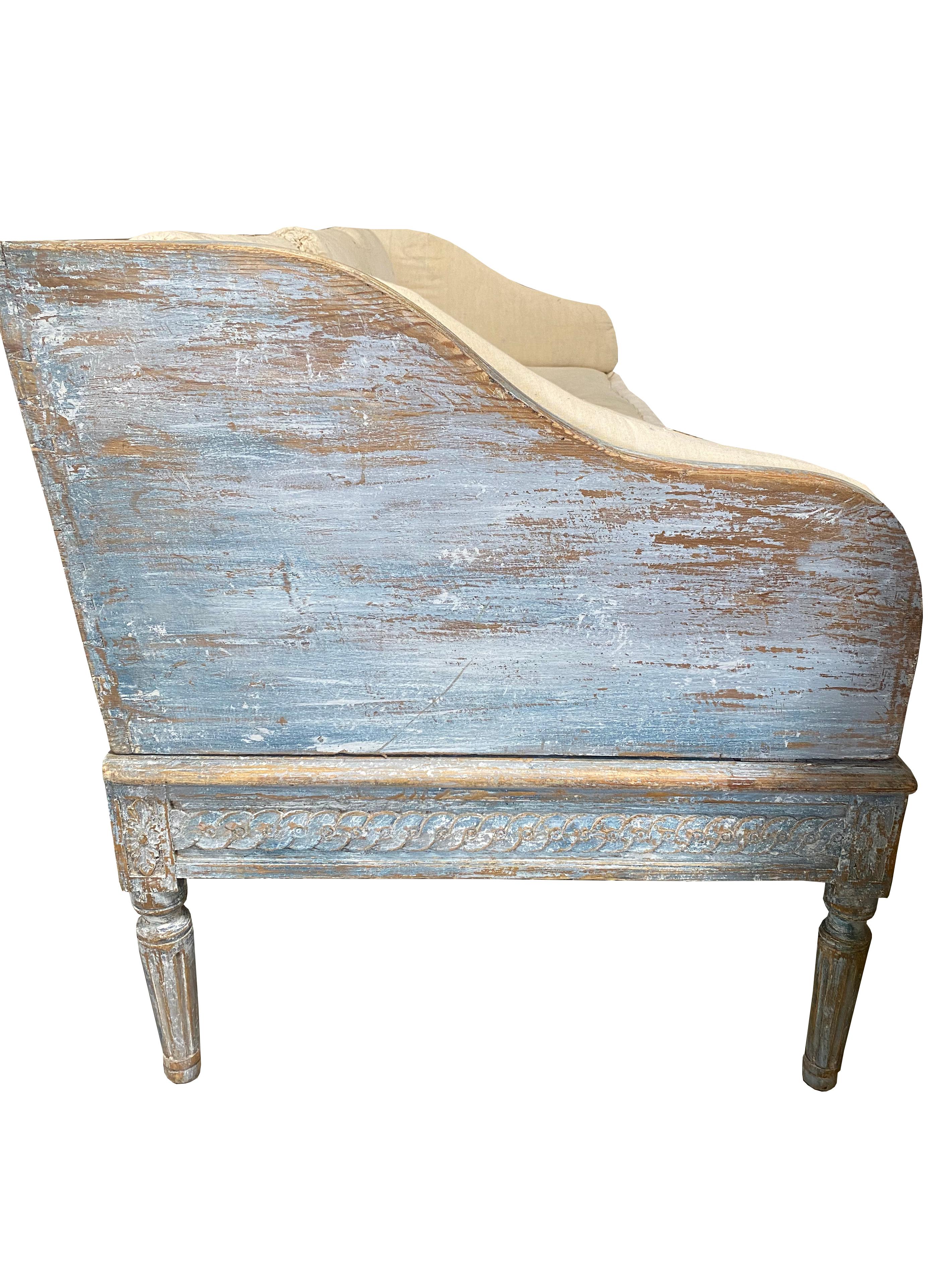 Swedish Simplicity at its best. This early 19th century Swedish Gustavian sofa is classic yet modern. It has the perfect Swedish simple curves and straight lines. The paint is original with touch ups and is the palest of blues with white hues. In