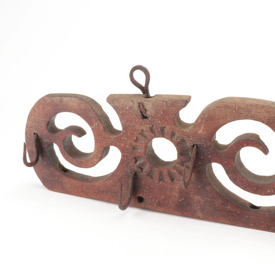 A gorgeous early 19th century hand carved game rack with eight hand wrought iron hooks. Game racks are used to hang small game meat such as fowl, rabbits, etc to dry after a hunt. They were also used to dry herbs. This piece has lovely carved