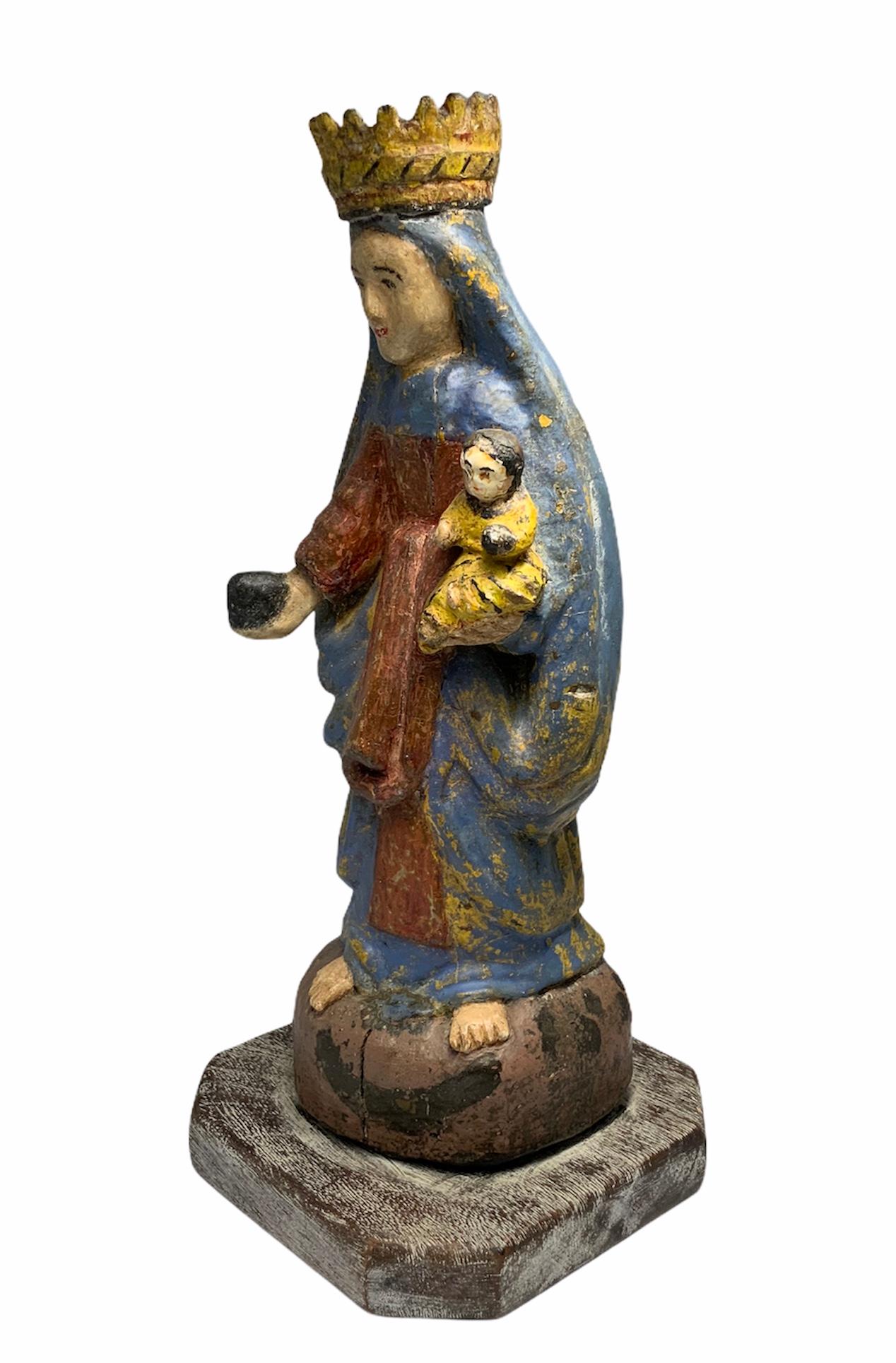 This carved wood colorful sculpture is handmade & painted by an unknown puerto rican craftsman. The Virgen del Carmen is the patron saint of fisherman sailors and seaports. Also, believers request of her to protect their family or pray to her to