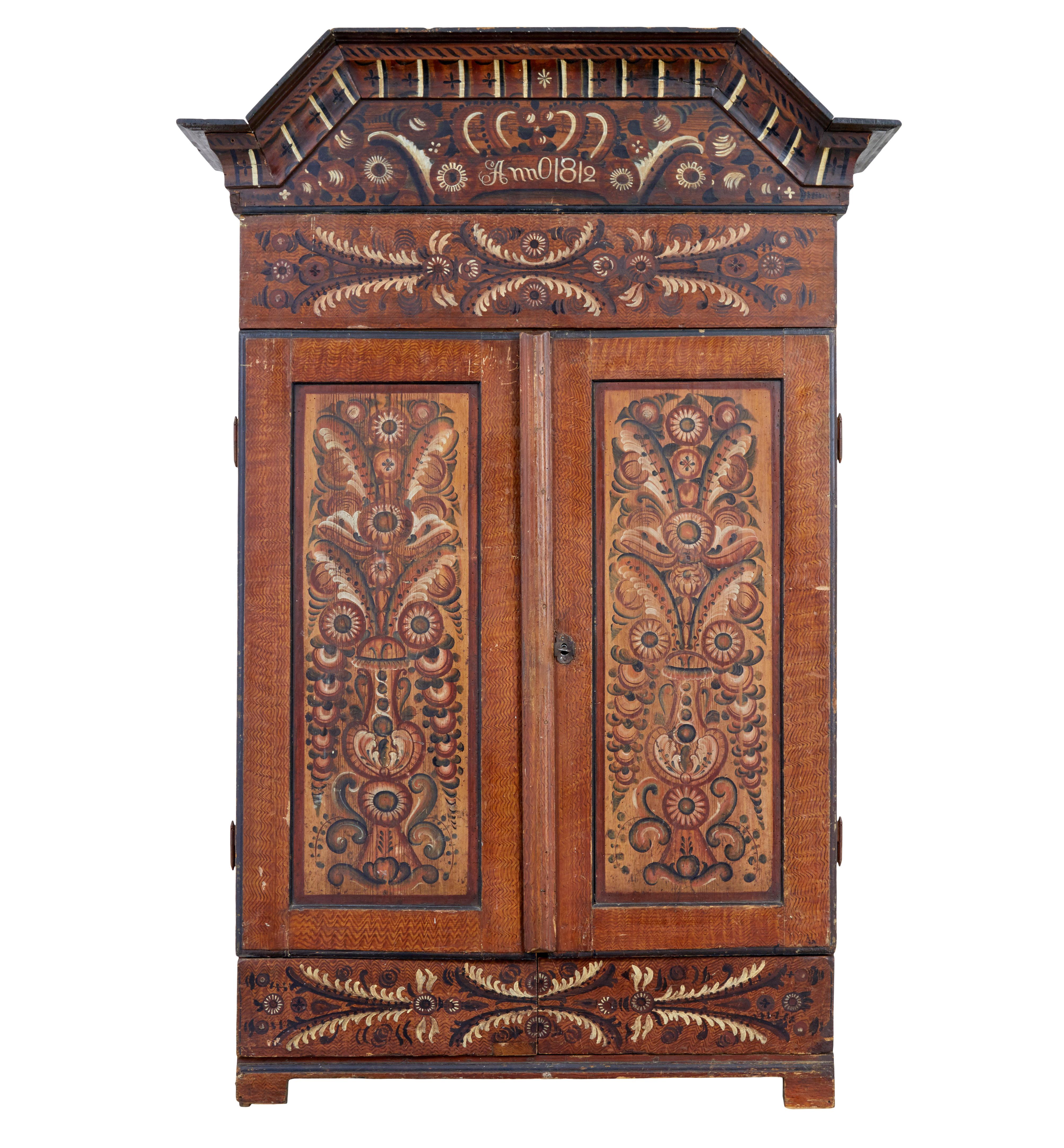 Early 19th century hand painted Swedish cupboard circa 1812.

Fine quality example of Swedish hand painted folk art in the form of a cupboard.

Painted in a tonal brown wash with ragwork elements and hand painted florals and designs to all