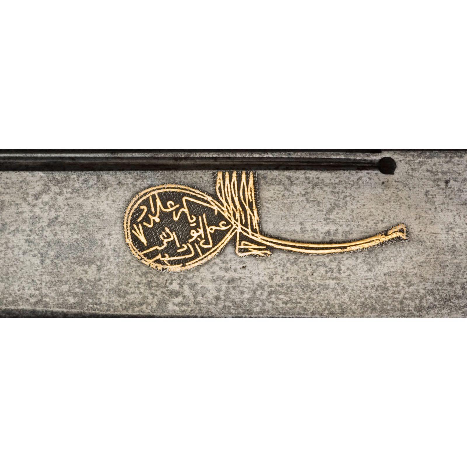An Ottoman Yataghan with the blade engraved in gold inlaid with the maker’s name and dated to 1222 H.D.

Measures: Sword 73 cm 
Blade: 57 cm.
    