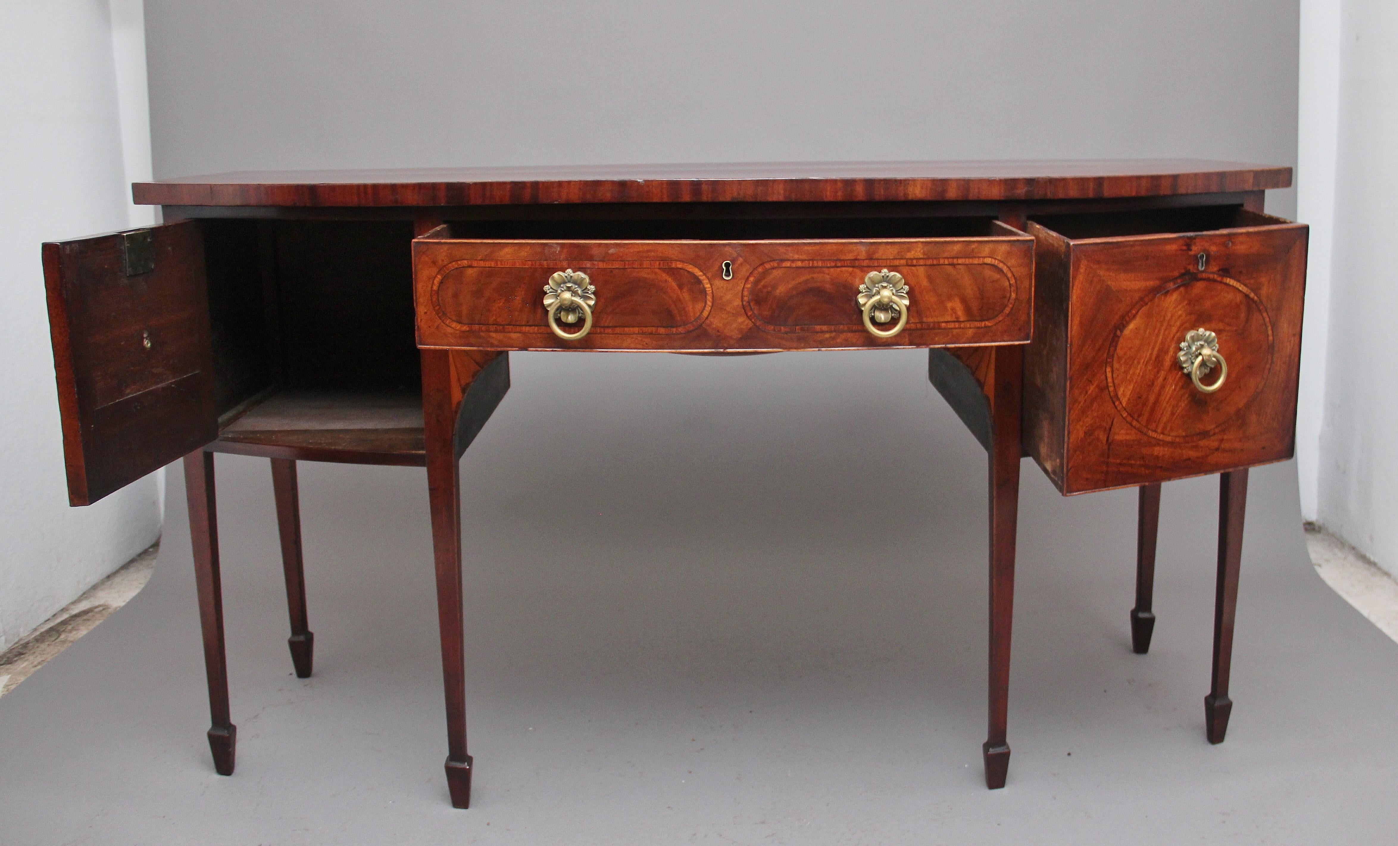 Early 19th century mahogany bow front sideboard, having a lovely figured top and crossbanded around the edge, having a central oak lined drawer below flanked either side with a cupboard and a deep oak lined cellerette drawer, the drawer fronts
