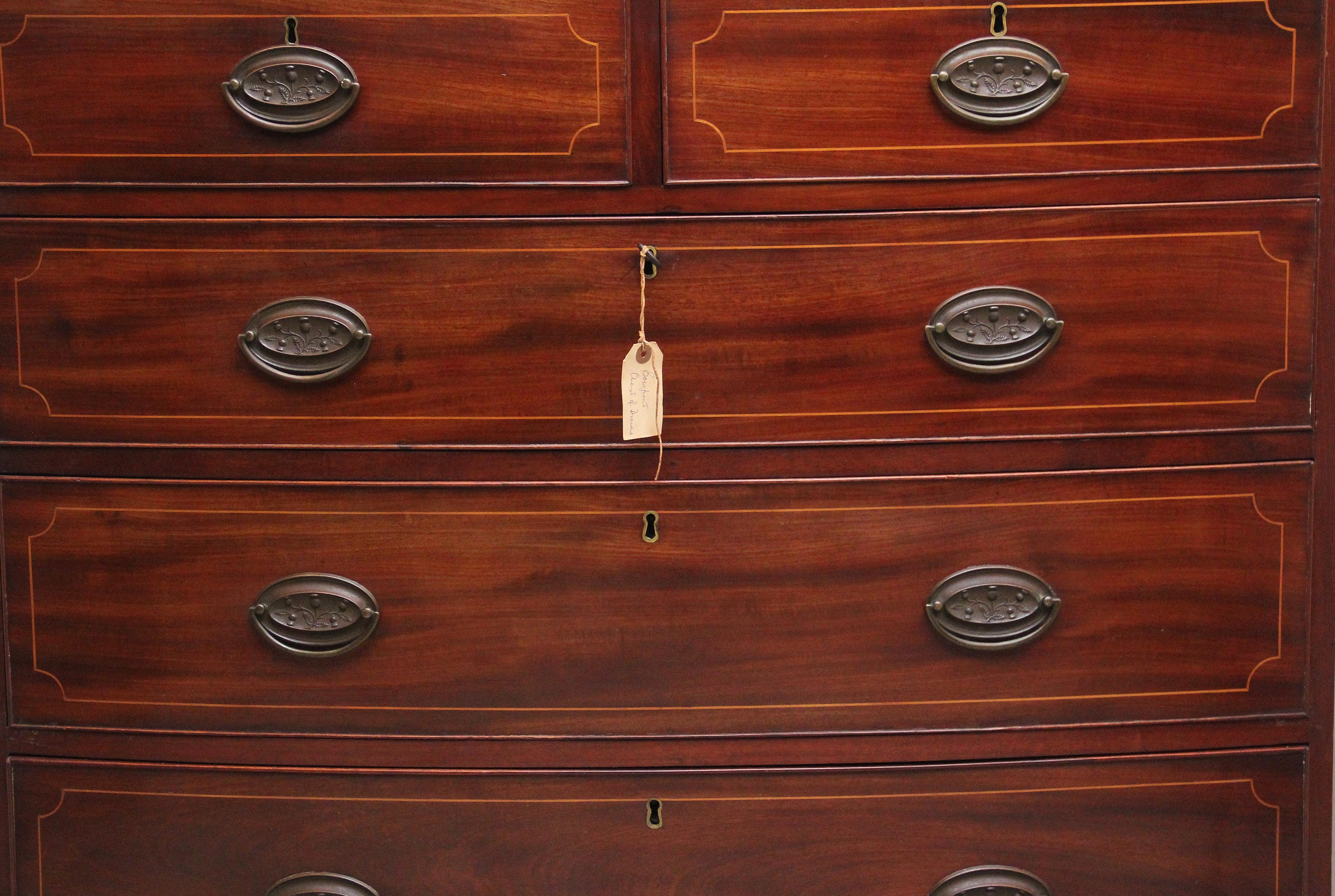 Early 19th Century inlaid mahogany bowfront chest of drawers, having a nice figured top above a selection of two short over three long graduated drawers with oval brass handles, nice decorative inlay on the drawer fronts, shaped apron below and