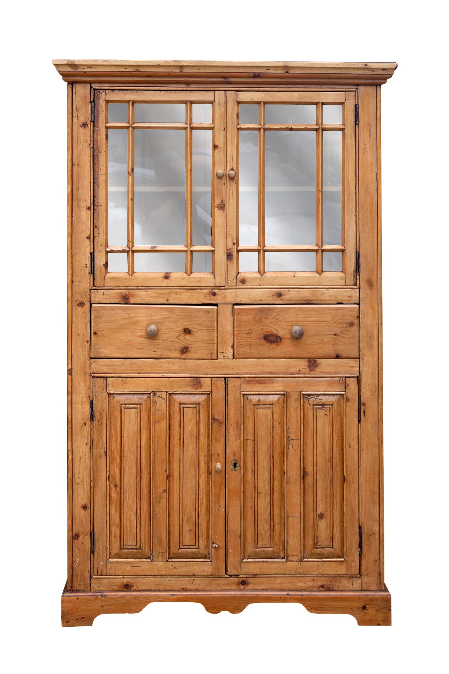 Charming antique Irish pine hutch featuring the original glass paned cabinet doors above with shelf for display & storage.
Beautiful, aged patina with some natural distressing. Very mellow soft hand to the finish. A cabinetmakers piece with pegged