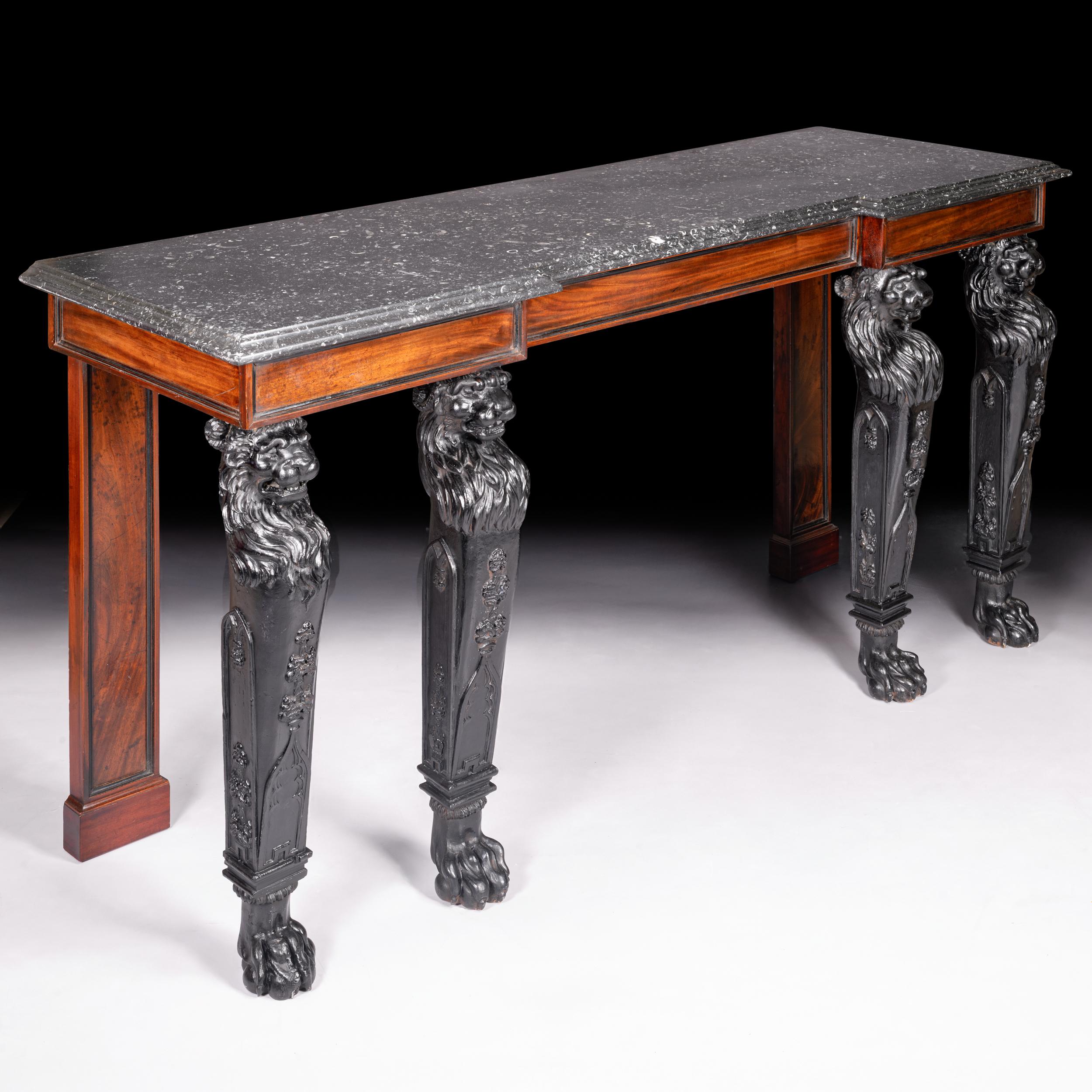 A very fine and impressive Irish Regency mahogany & ebonised console table, of inverted breakfront outline, fitted with an inverted breakfront Kilkenny fossil marble top over a plain compartmented frieze and lion masked tapering legs, ending with