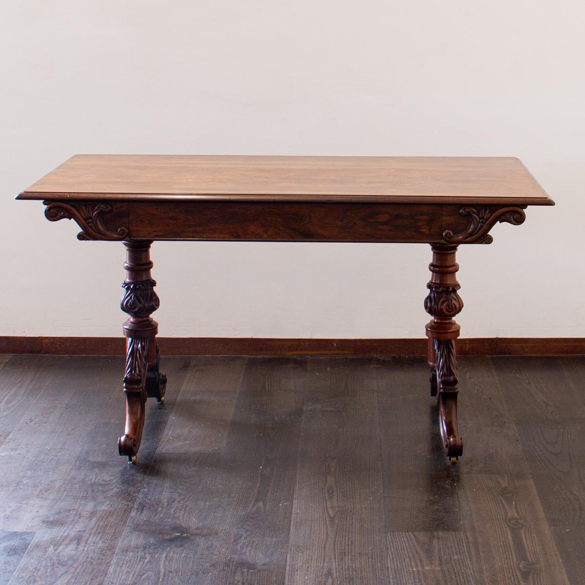 Early 19th century Irish rosewood occasional table which typifies the individual style of Mack Williams and Gibton's furniture, combining superb quality rosewood veneers, supported by a pair of robust acanthus carved legs together with a single