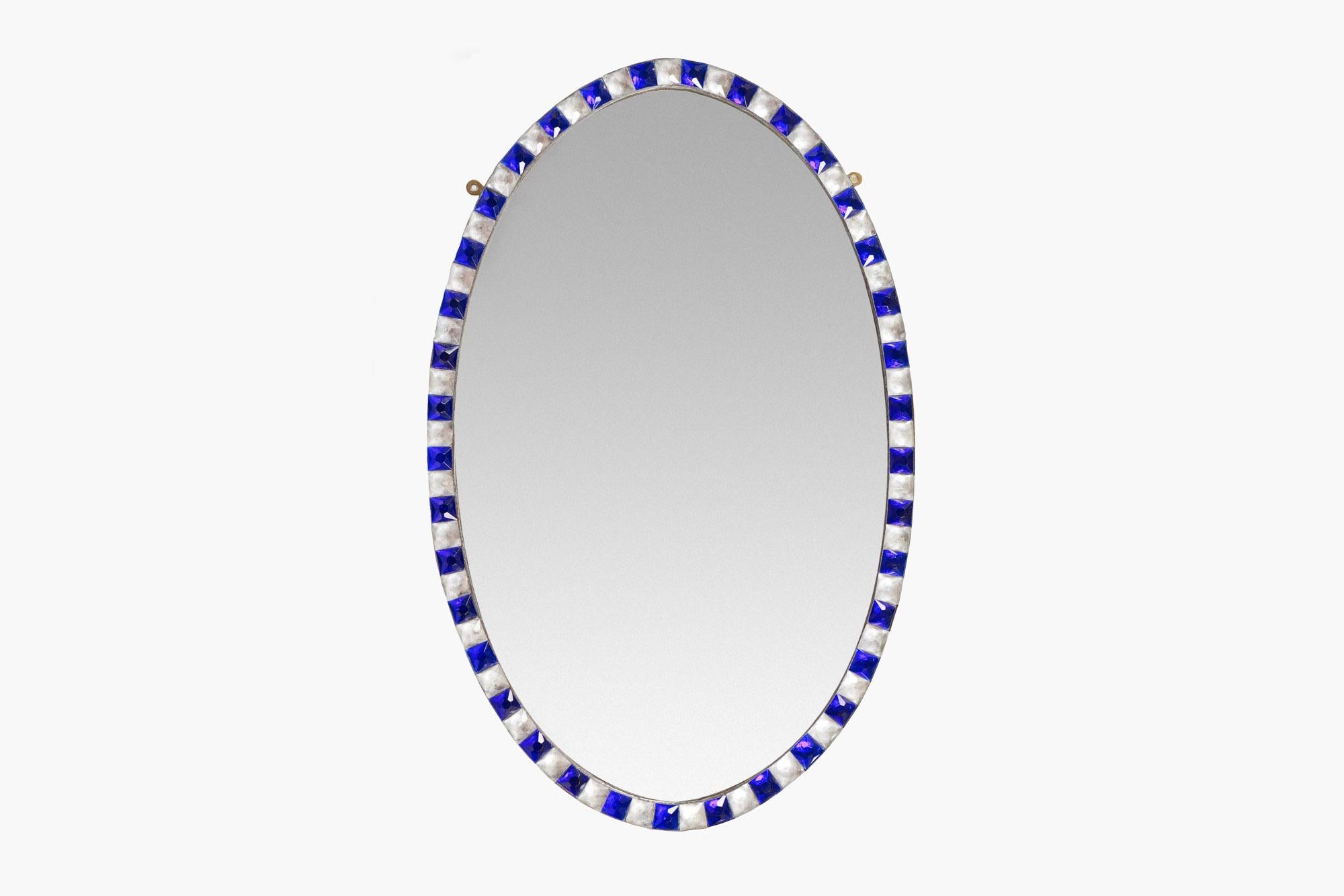 Early 19th century Irish Waterford mirror, the period plate of oval form set within frame of alternating faceted blue and clear glass studs.