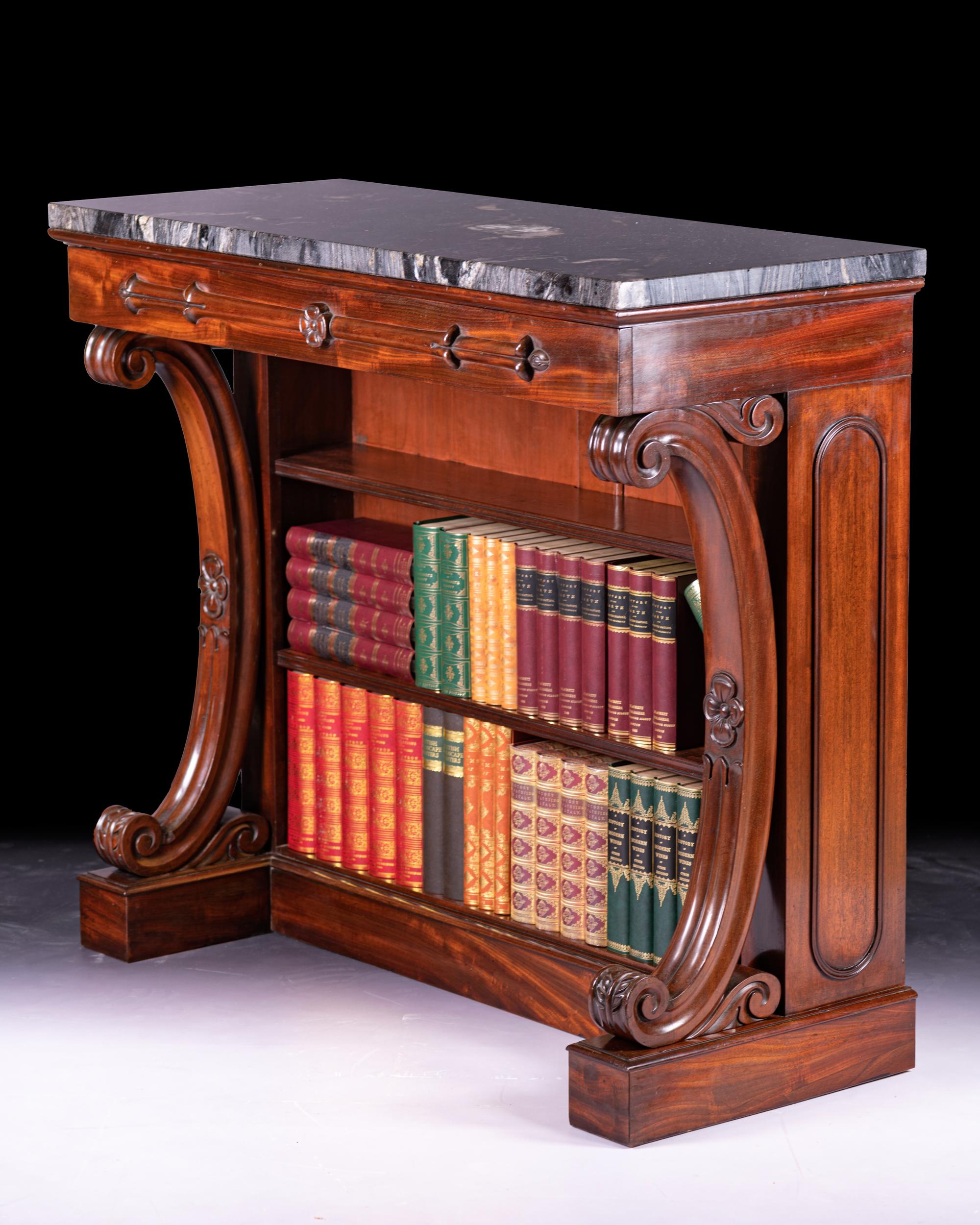 A very fine and most attractive Irish William IV period mahogany open bookcase/console table, of concave design, with grey marble panel above a hidden drawer set with rosettes and three open book tiers, on outset plinth base.

Circa 1830

Irish