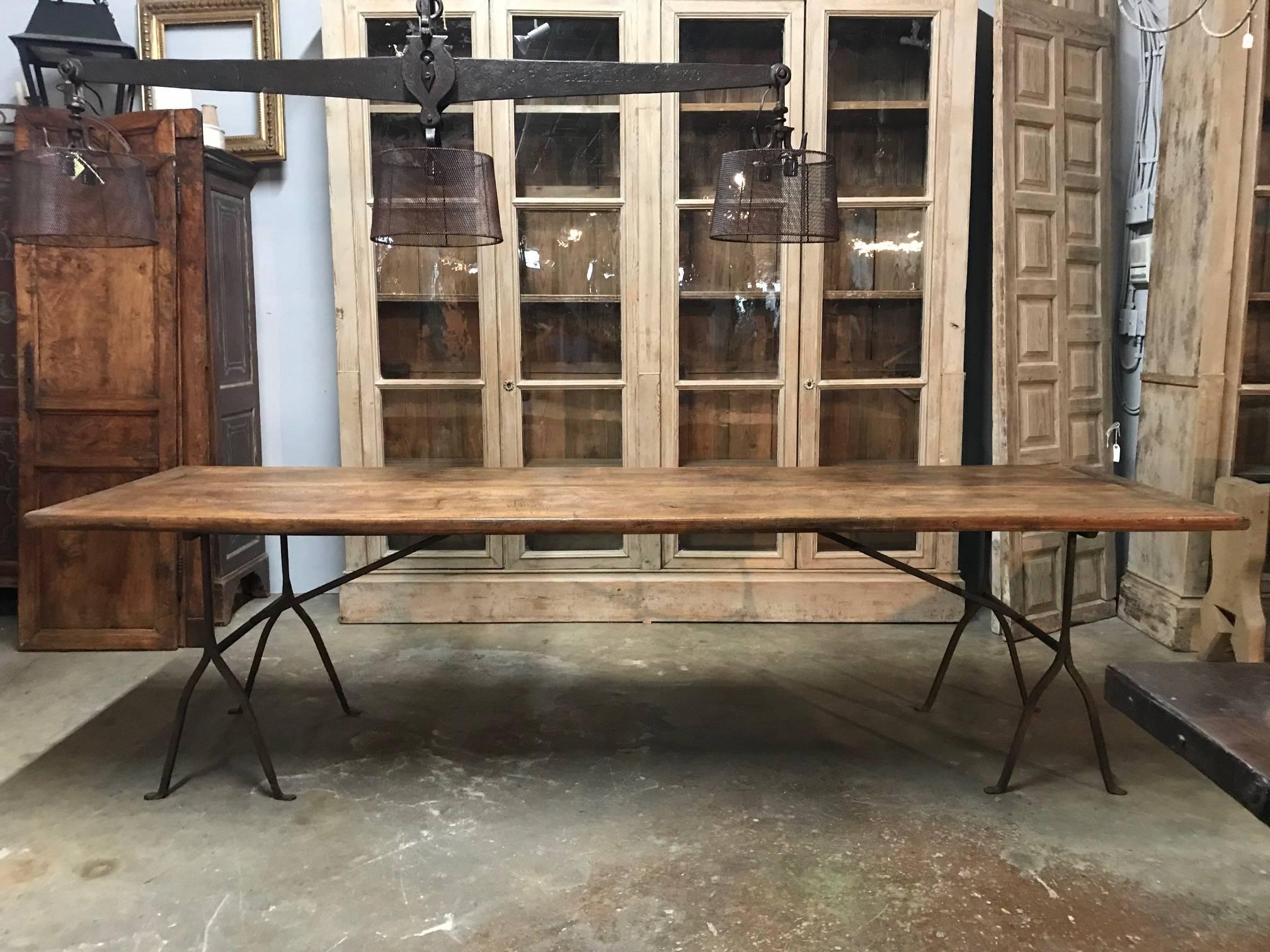 A very handsome early 19th century Northern Italian Dining Table with a very beautiful walnut top and iron base. Very sound and sturdy. Terrific patina. A wonderful table for any dining room or covered porch.