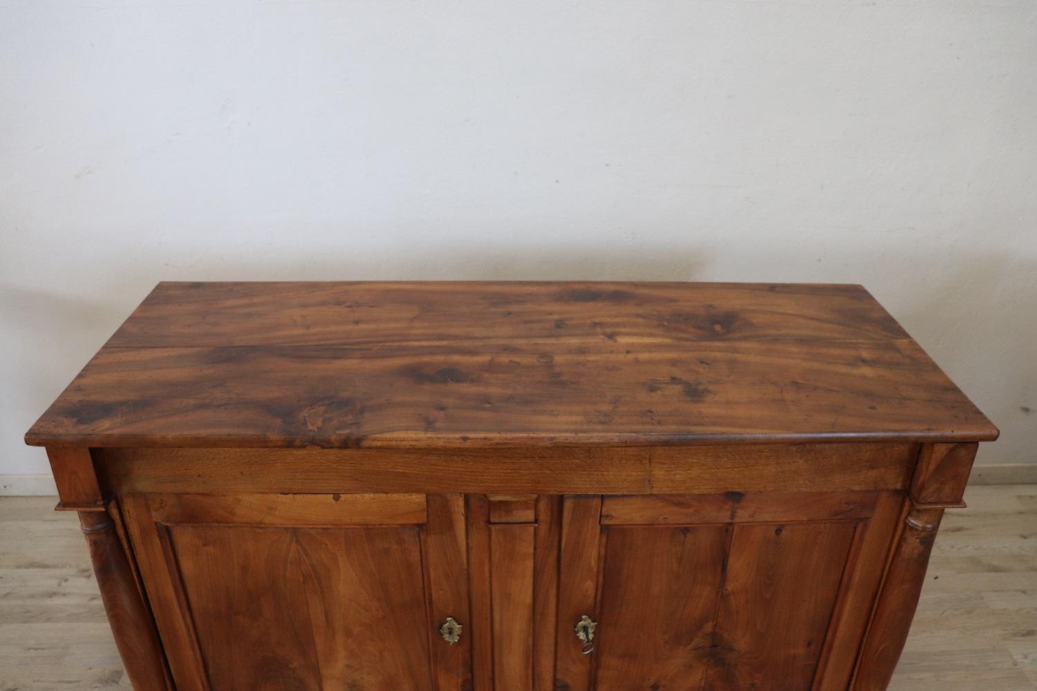 Important and rare antique empire solid walnut sideboard 1810s. Walnut wood has acquired a beautiful antique patina presenting the signs of all the past centuries. The signs of the passage of time on this sideboard top are a merit that certify its