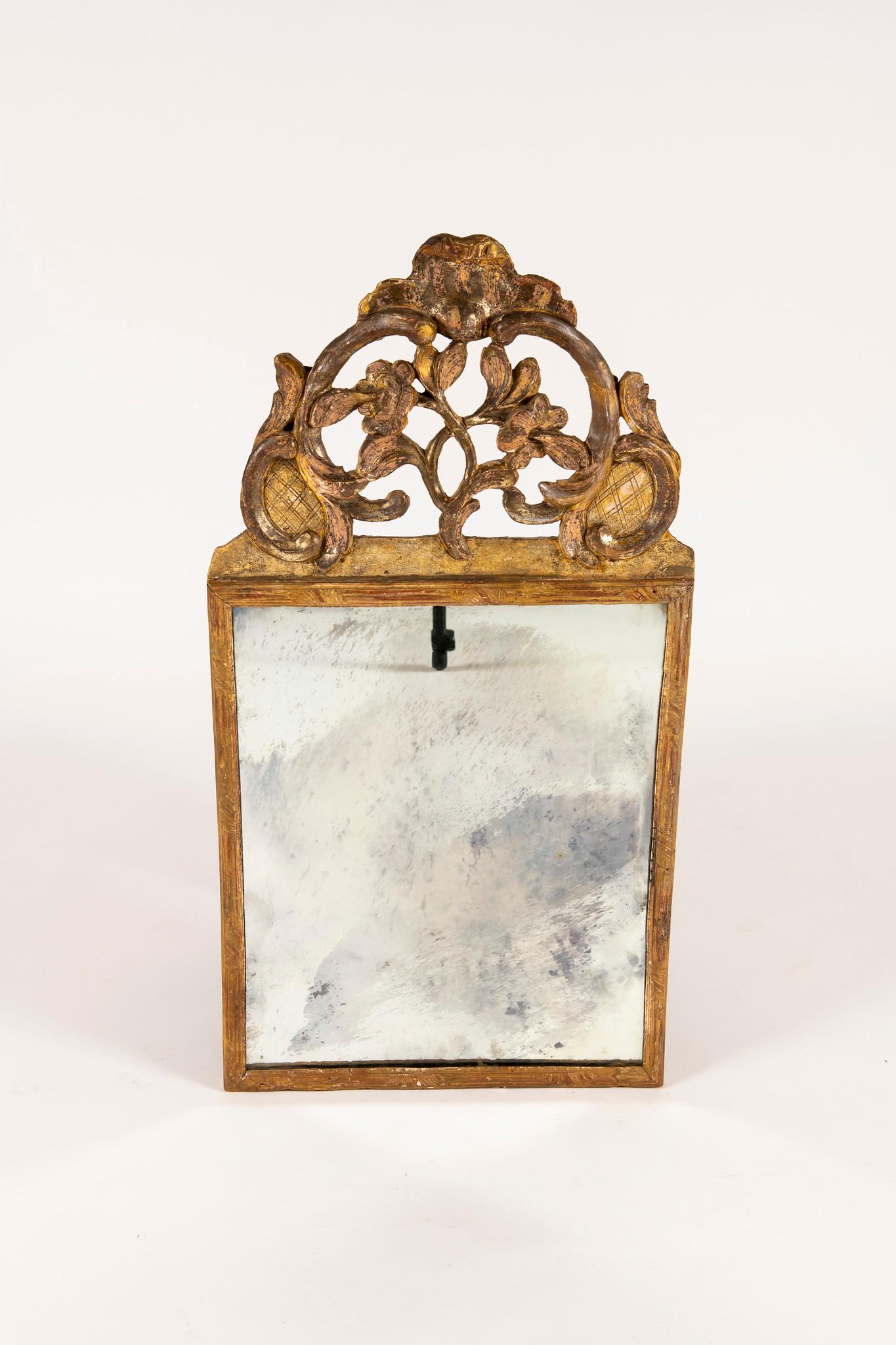 An early 19th century Italian parcel giltwood mirror with scrolling, flowers and shell cartouche.