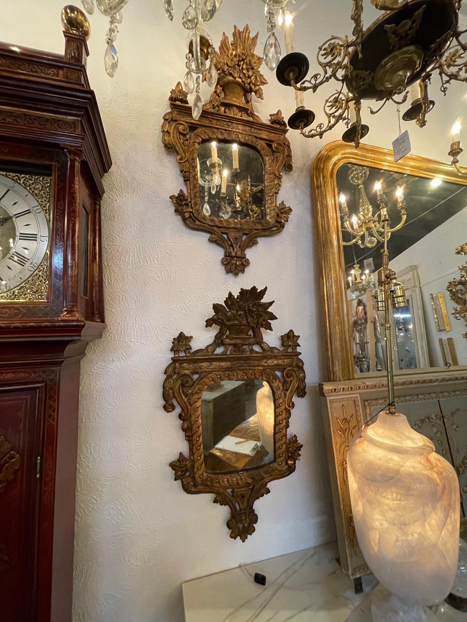 Beautiful early 19th century Italian giltwood mirrors. Exceptional carving on these including an urn overflowing with flowers. True works of art! Note: Price listed is per item.