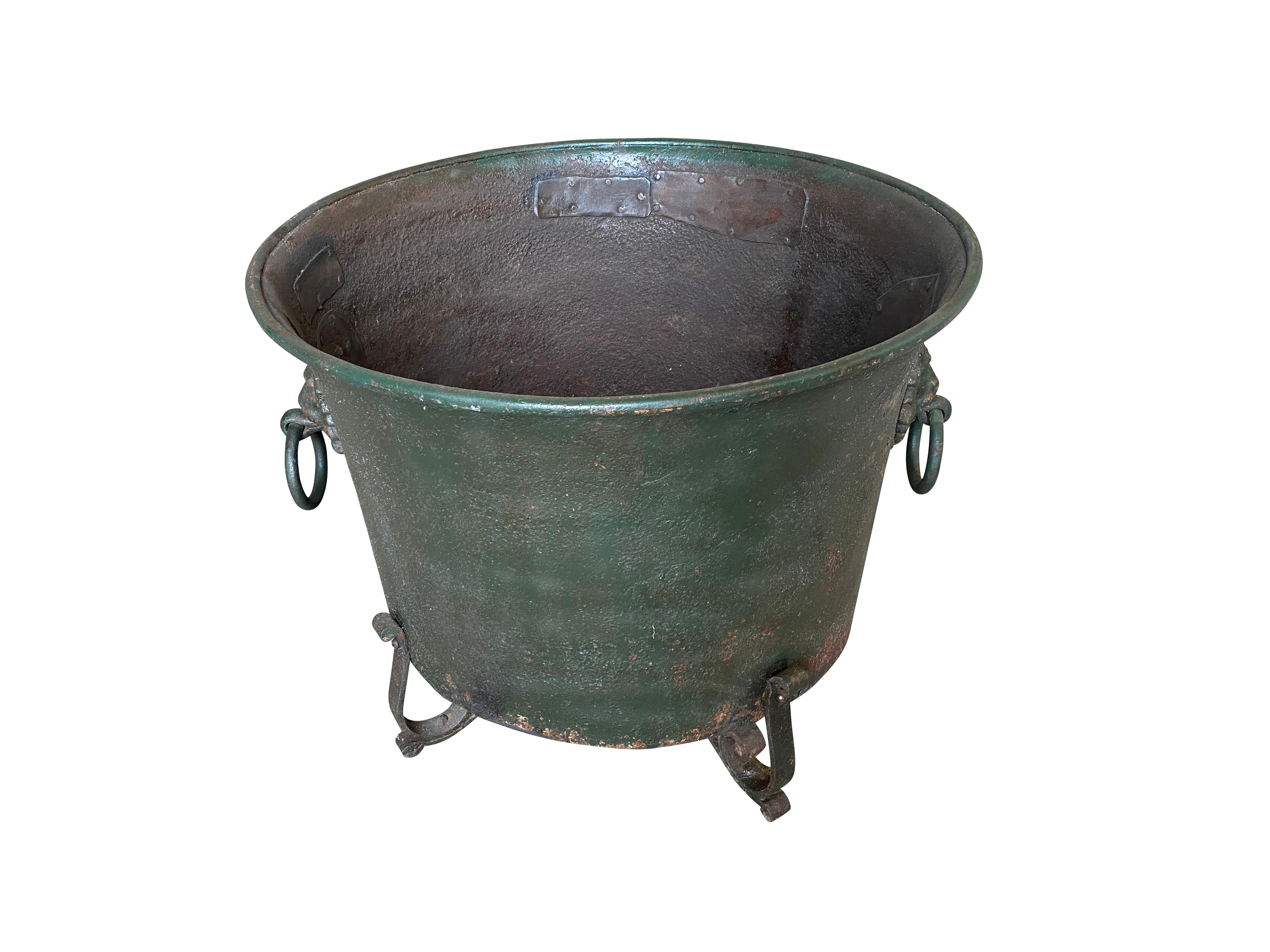 A very handsome early 19th century Jardiniere from the Genoa region of Italy. Beautifully crafted from painted iron with lion's head handles and raised on feet.