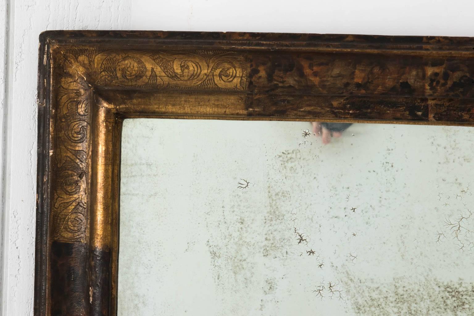 Gilded Italian mirror with hand-painted S-scroll foliage detailed on the corners, circa early 19th century.
 