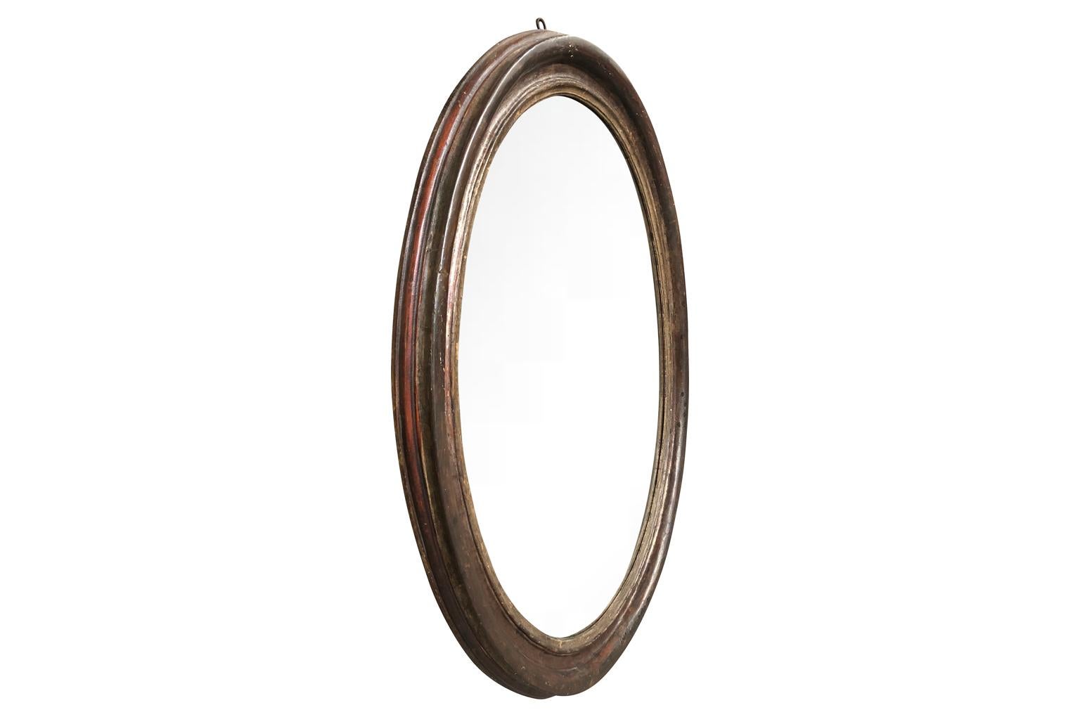 A very stunning 18th century oval shaped frame now as mirror from the Veneto region of Italy in polychromed wood. Beautiful color and patina.