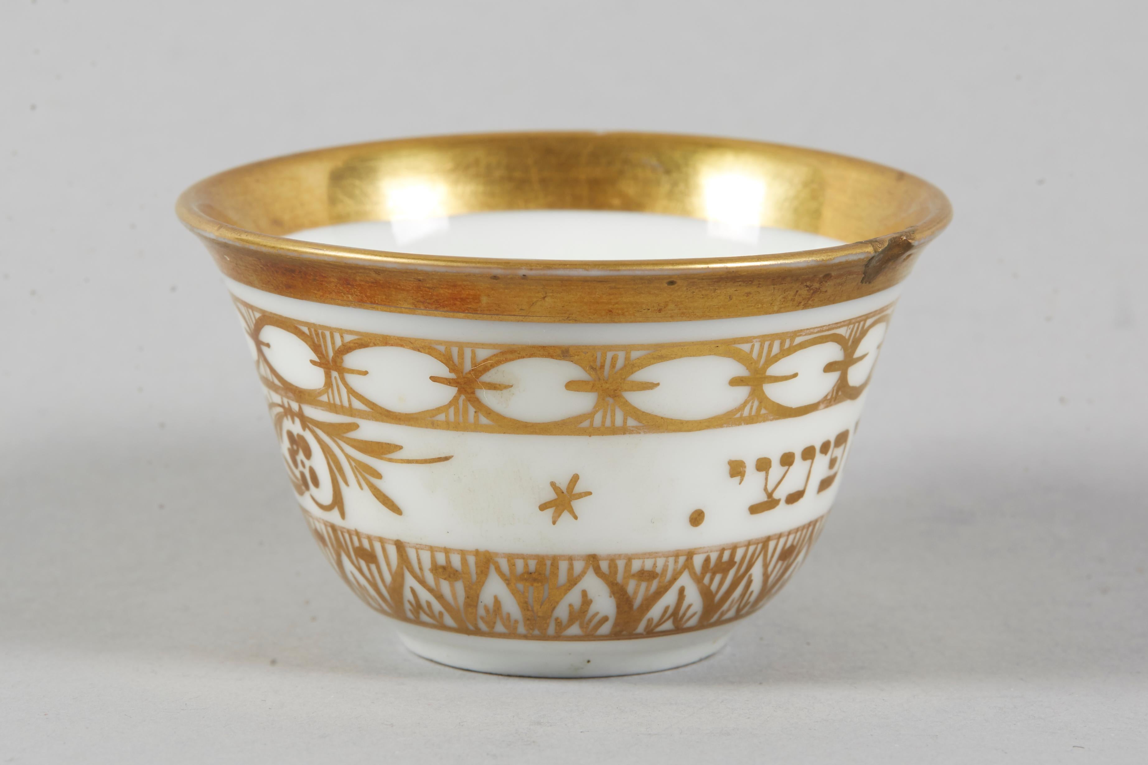 Small porcelain Kiddush cup, Italy, circa 1810.
Gold painted, decorated with floral design, and bearing the Hebrew owner's name: Moshe Finzi.

Kiddush cup is a ceremonial vessel to hold wine for the blessing said at Shabbat and Jewish holidays