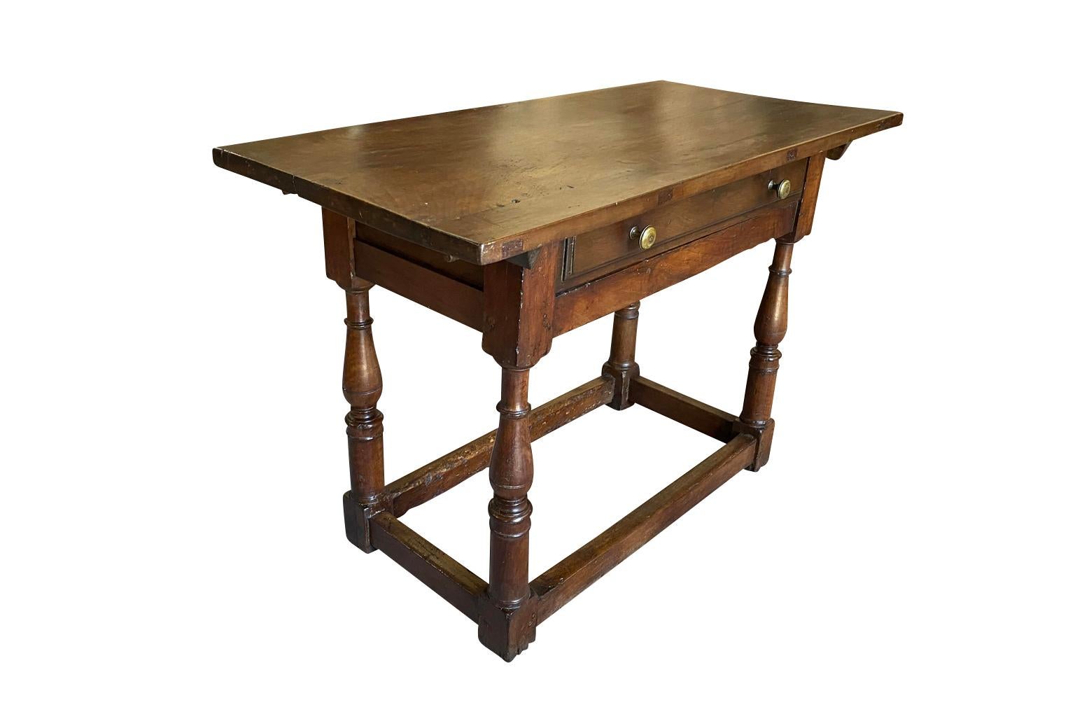 A very lovely early 19th century diminutive console or side table from the Bologna region of Italy. Wonderfully constructed from stunning walnut with a single drawer and nicely turned legs. Beautiful patina.