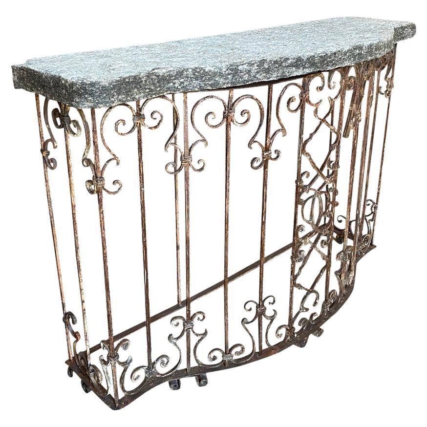 A sensational early 19th century Italian console table constructed from a stunning balcony grille with a fabulous very thick stone top.  Wonderful quality.  Perfect for any interior or exterior environment.