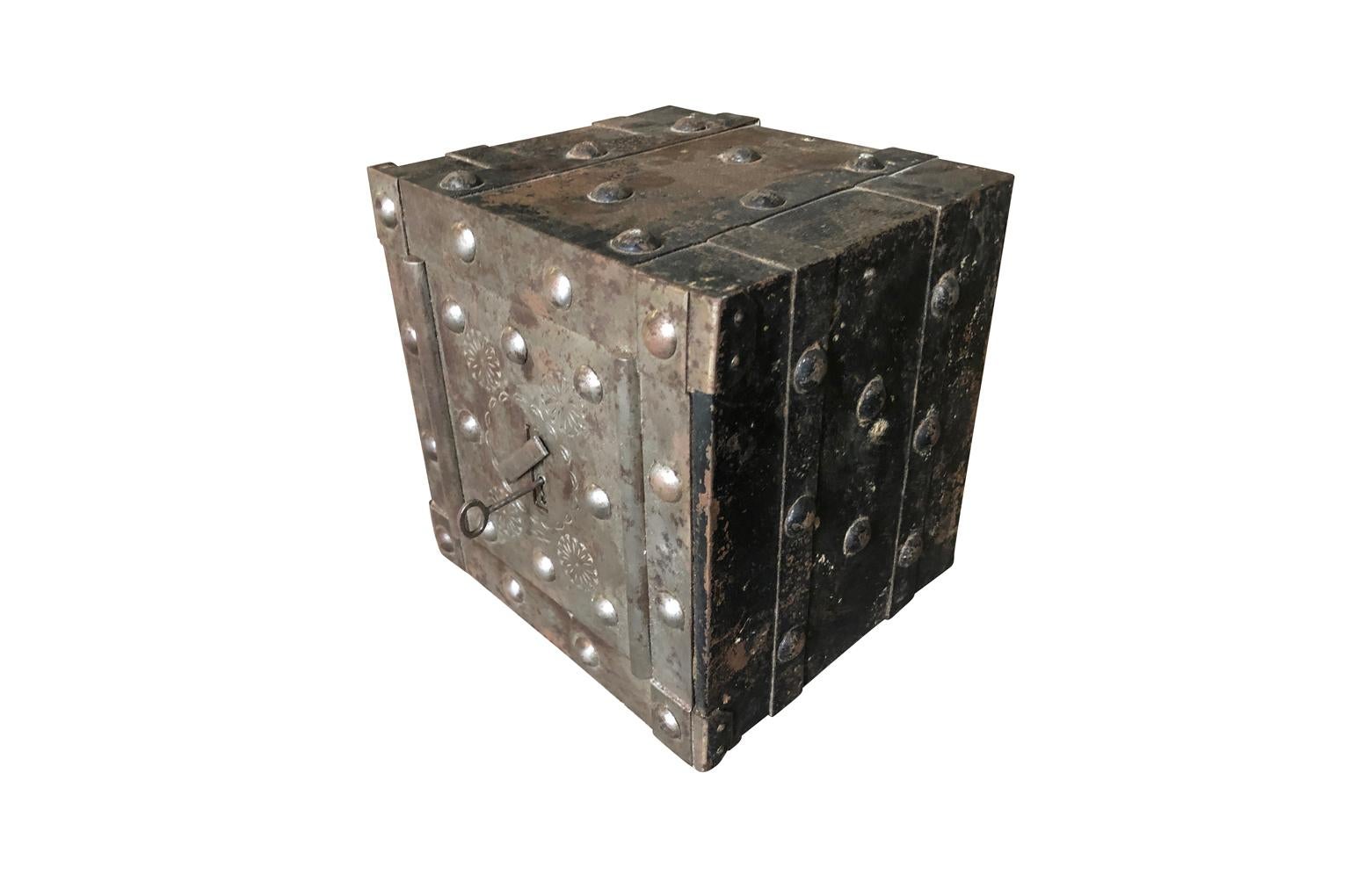A very handsome early 19th century strong box in iron from Northern Italy. Wonderfully constructed with iron straps and clavos and the original key. Its nice smaller size makes it perfect for an accent piece to sit atop a dresser, desk or place in a